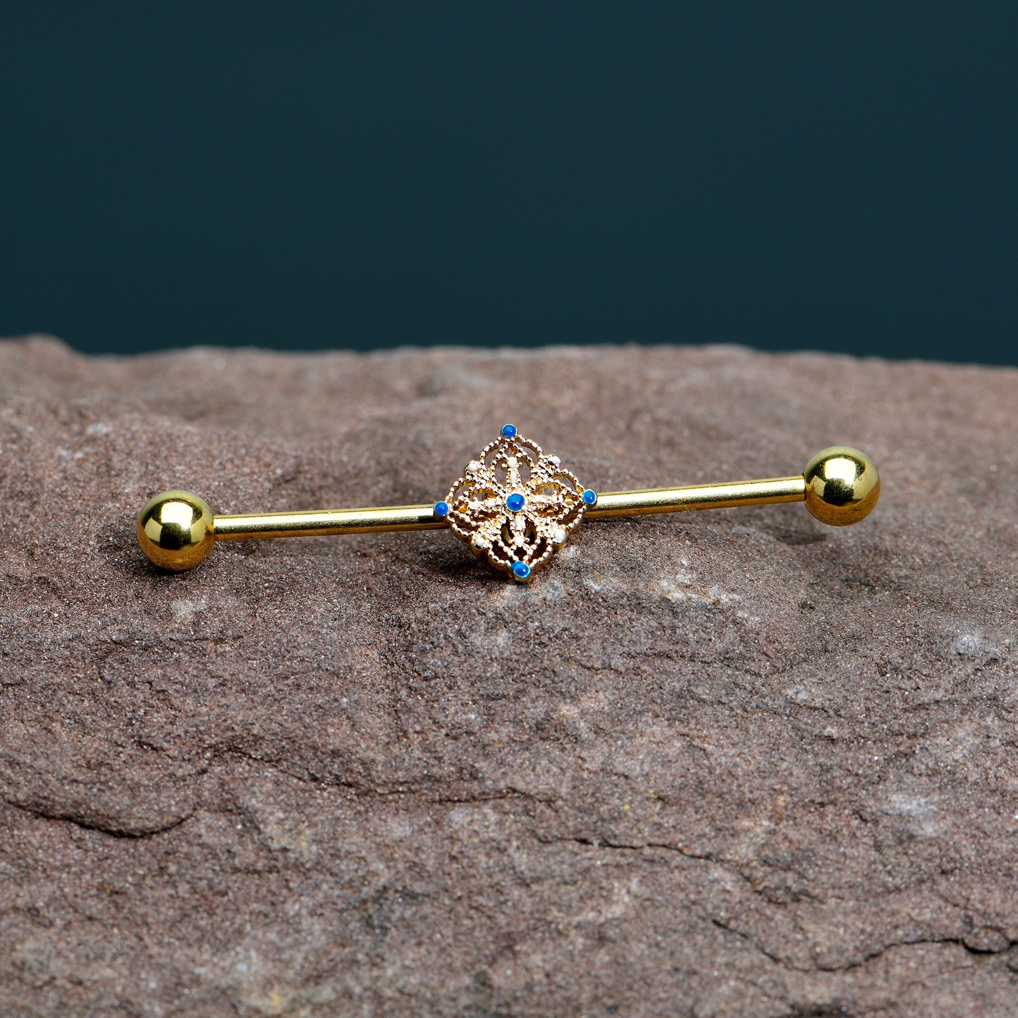BodyCandy 14G Blue Gem Gold Tone Texture Emblem Industrial Barbell 38mm — in-use photo