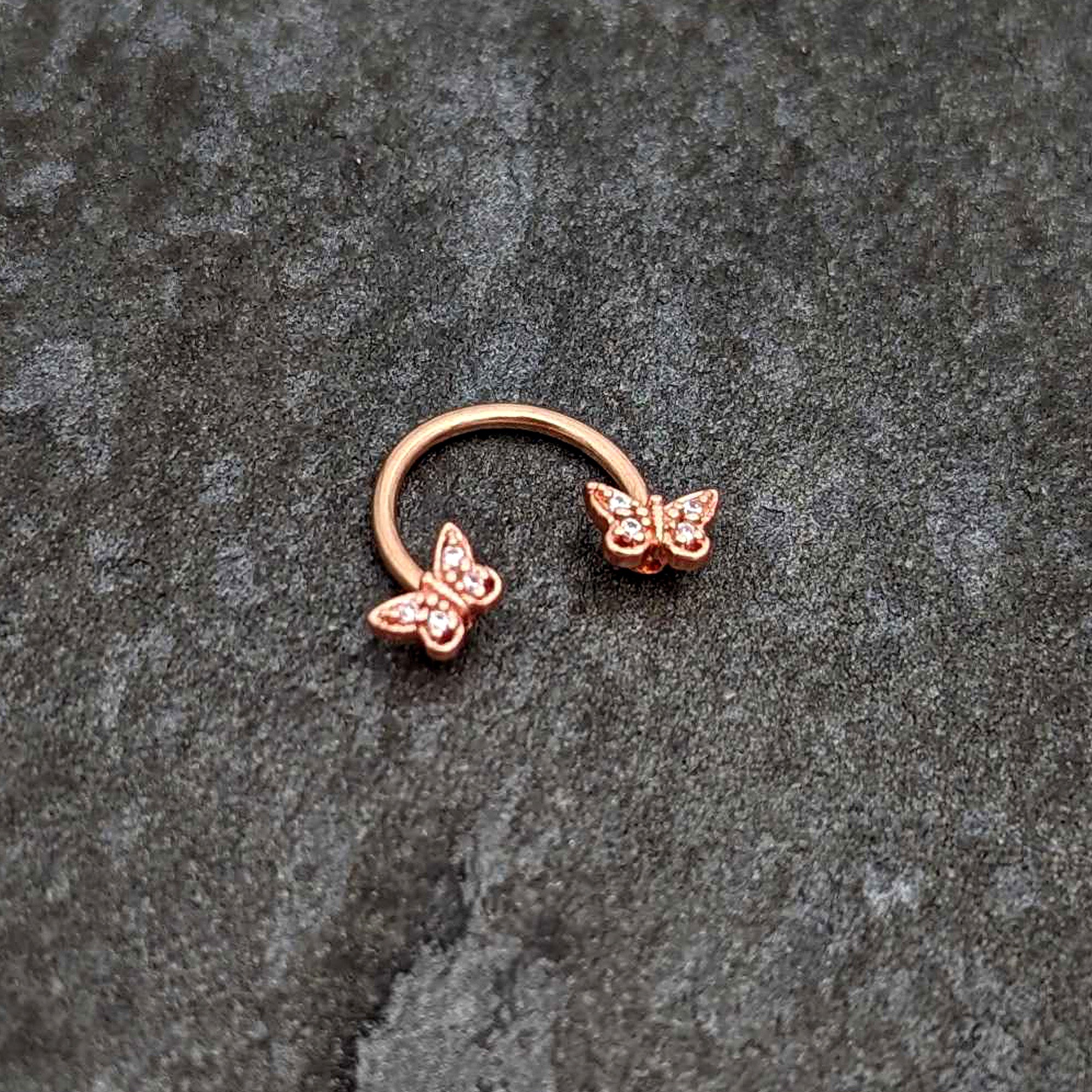 BodyCandy 16G 3/8 Clear Gem Rosy Tone Butterfly Horseshoe Circular Barbell — side view