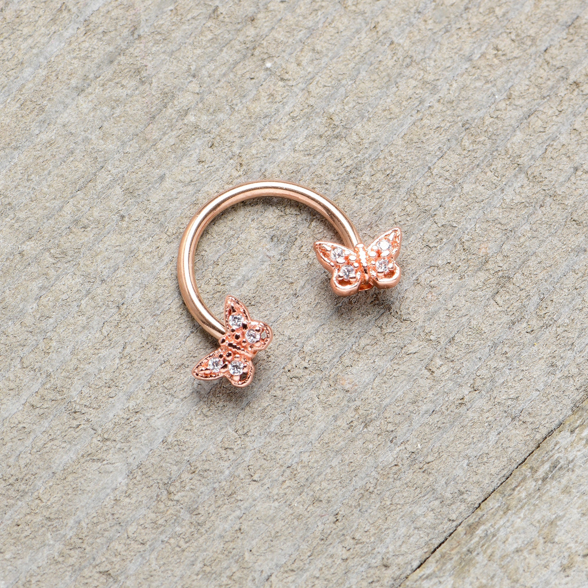 BodyCandy 16G 3/8 Clear Gem Rosy Tone Butterfly Horseshoe Circular Barbell — in-use photo