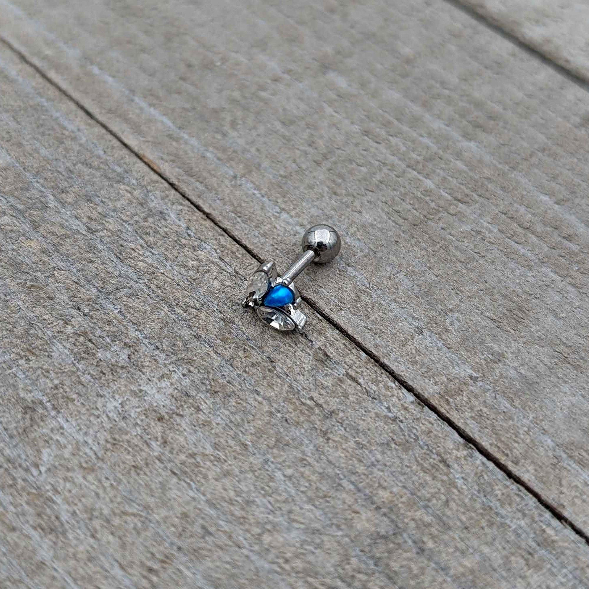 BodyCandy 16G 1/4 Blue Synthetic Opal Style Flower Cartilage Tragus Earring — in-use photo
