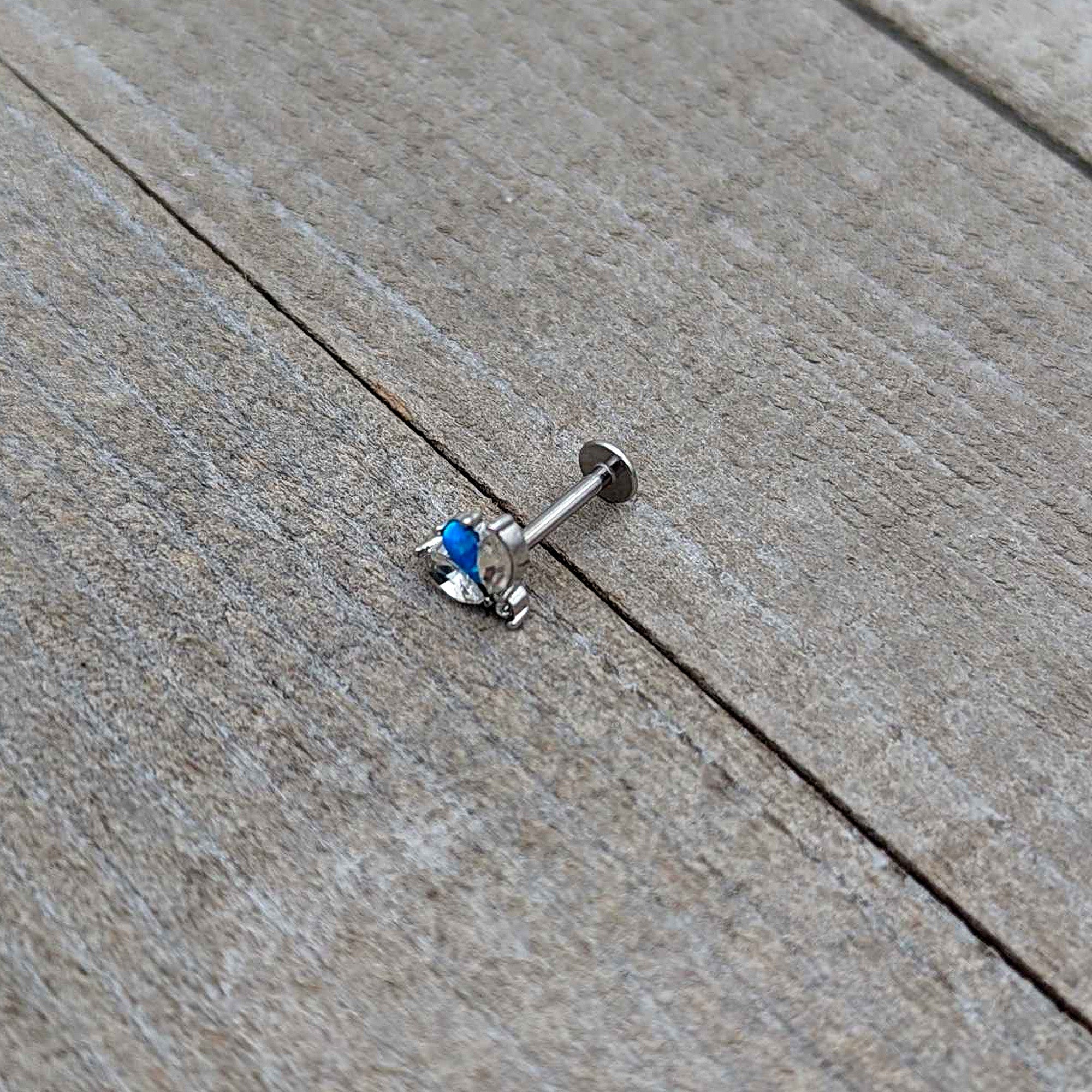 BodyCandy 16G 5/16 Blue Synthetic Opal Style Flower Labret Monroe Tragus — in-use photo