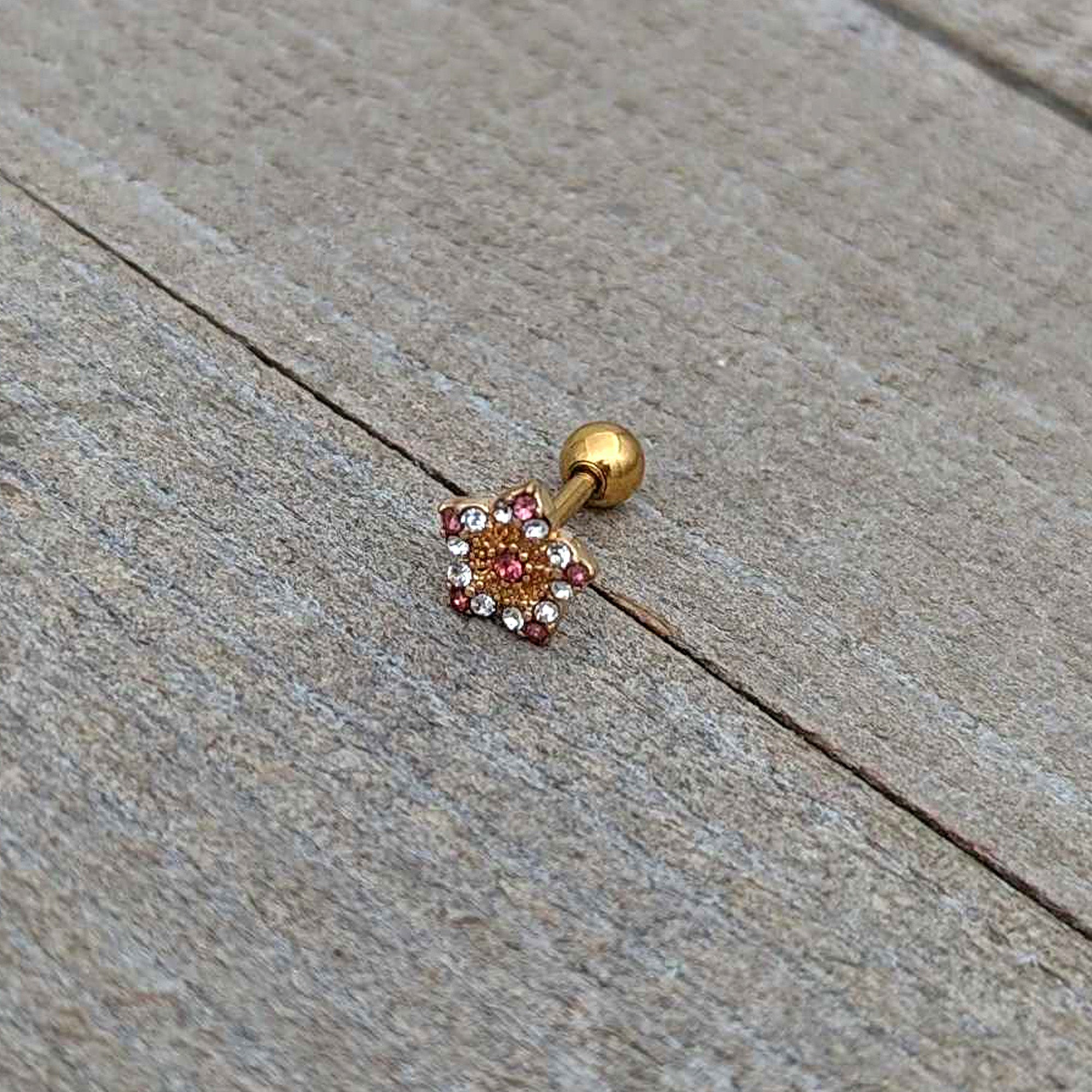 BodyCandy 16G 1/4 Pink Clear Gem Gold Tone Texture Star Cartilage Earring — in-use photo