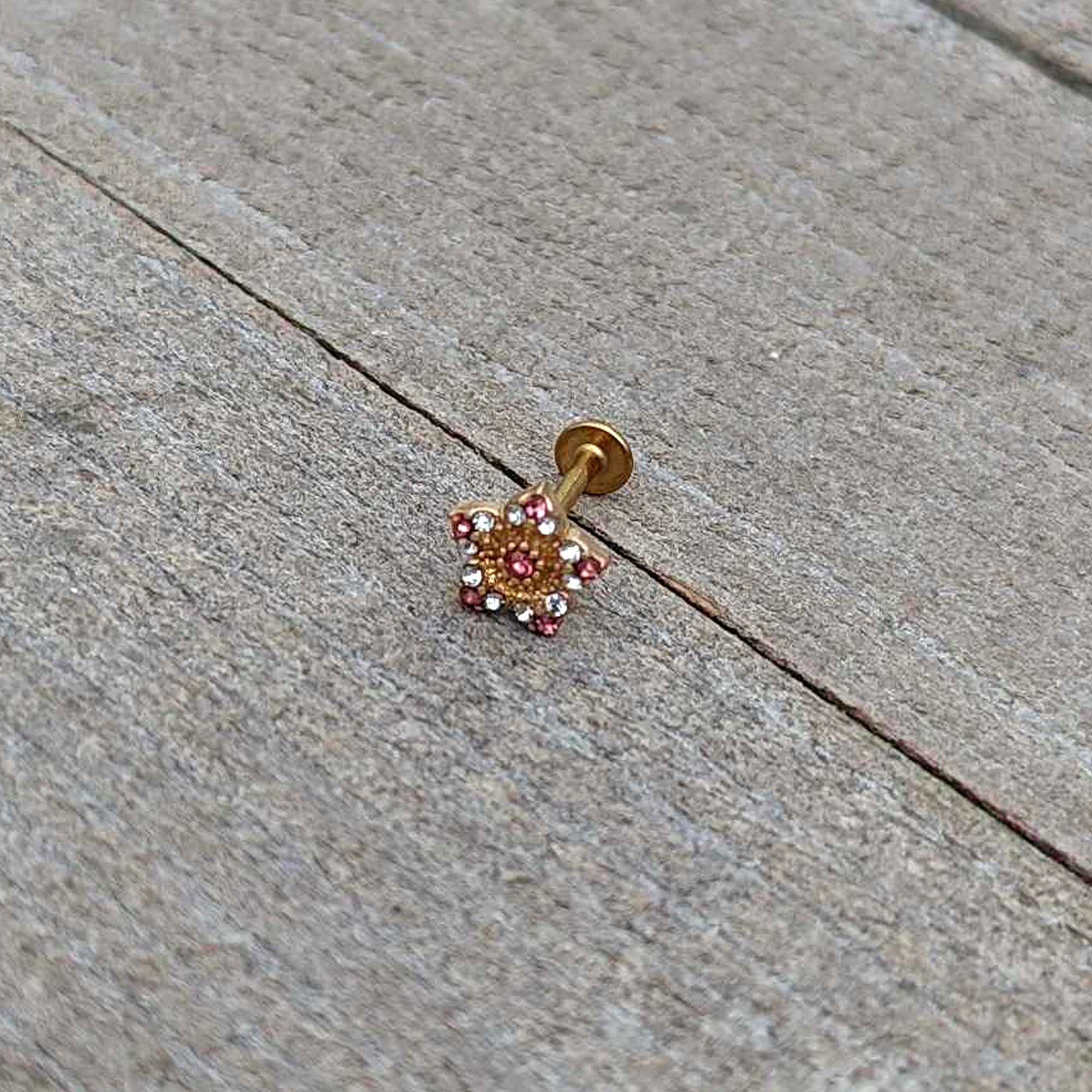 BodyCandy 16G 5/16 Pink Gem Gold Tone Texture Star Labret Monroe Tragus — in-use photo