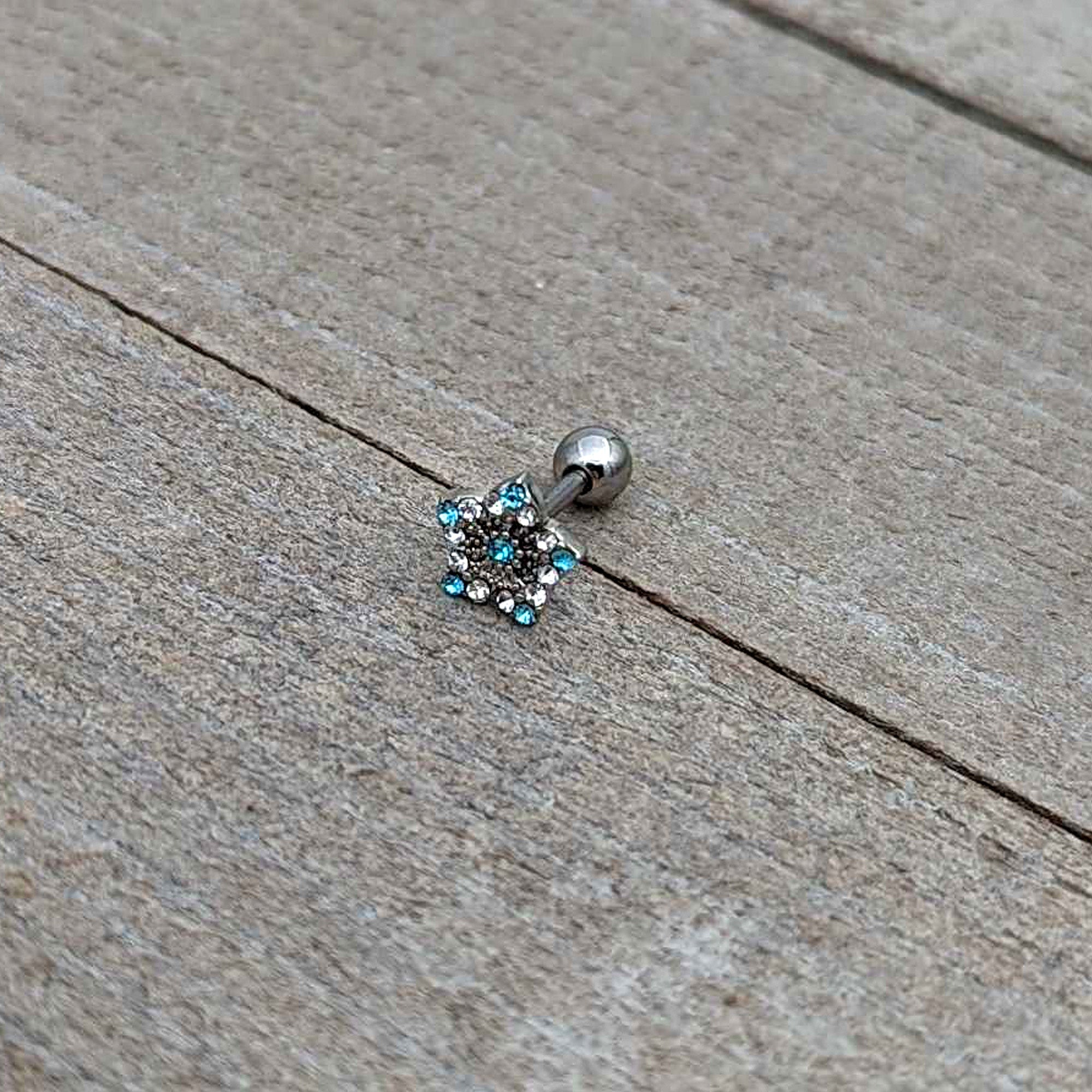 BodyCandy 16G 1/4 Blue Clear Gem Opulent Flower Cartilage Tragus Earring — in-use photo