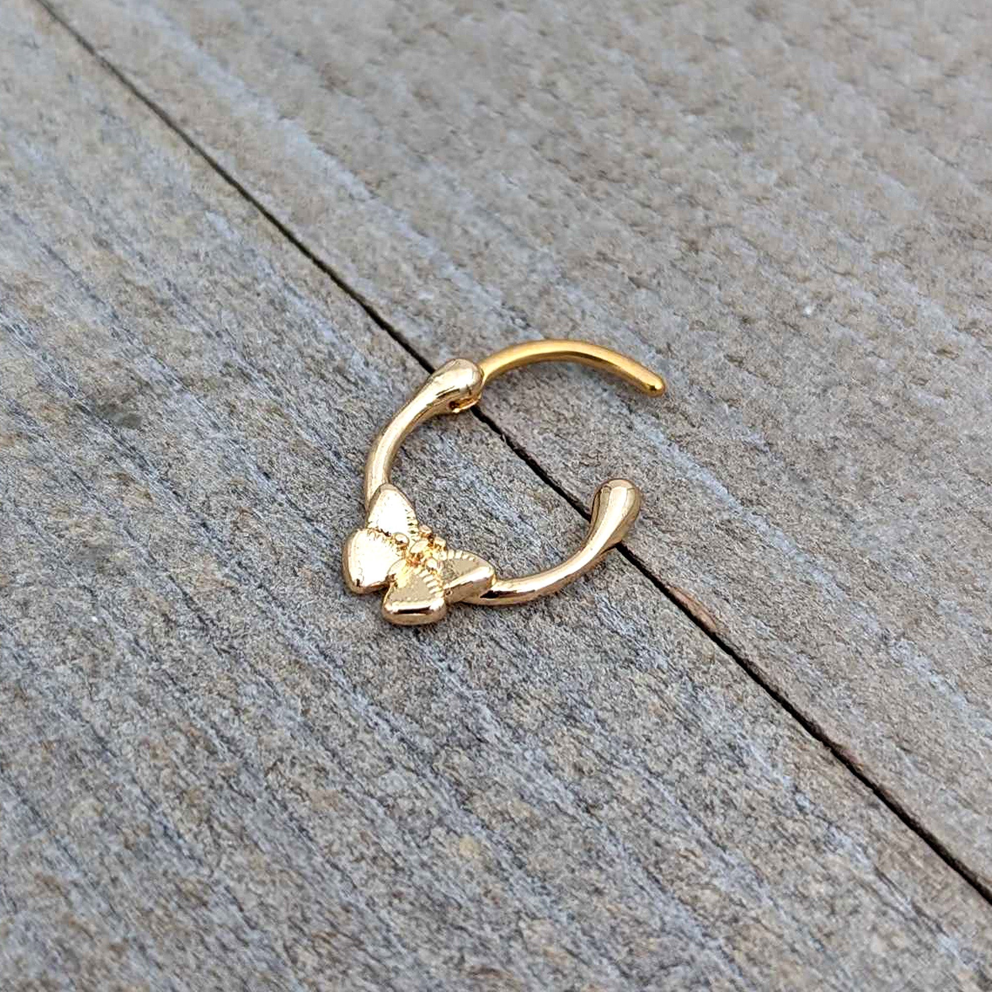 BodyCandy 16G 5/16 Gold Tone Simple Textured Butterfly Cartilage Clicker — in-use photo