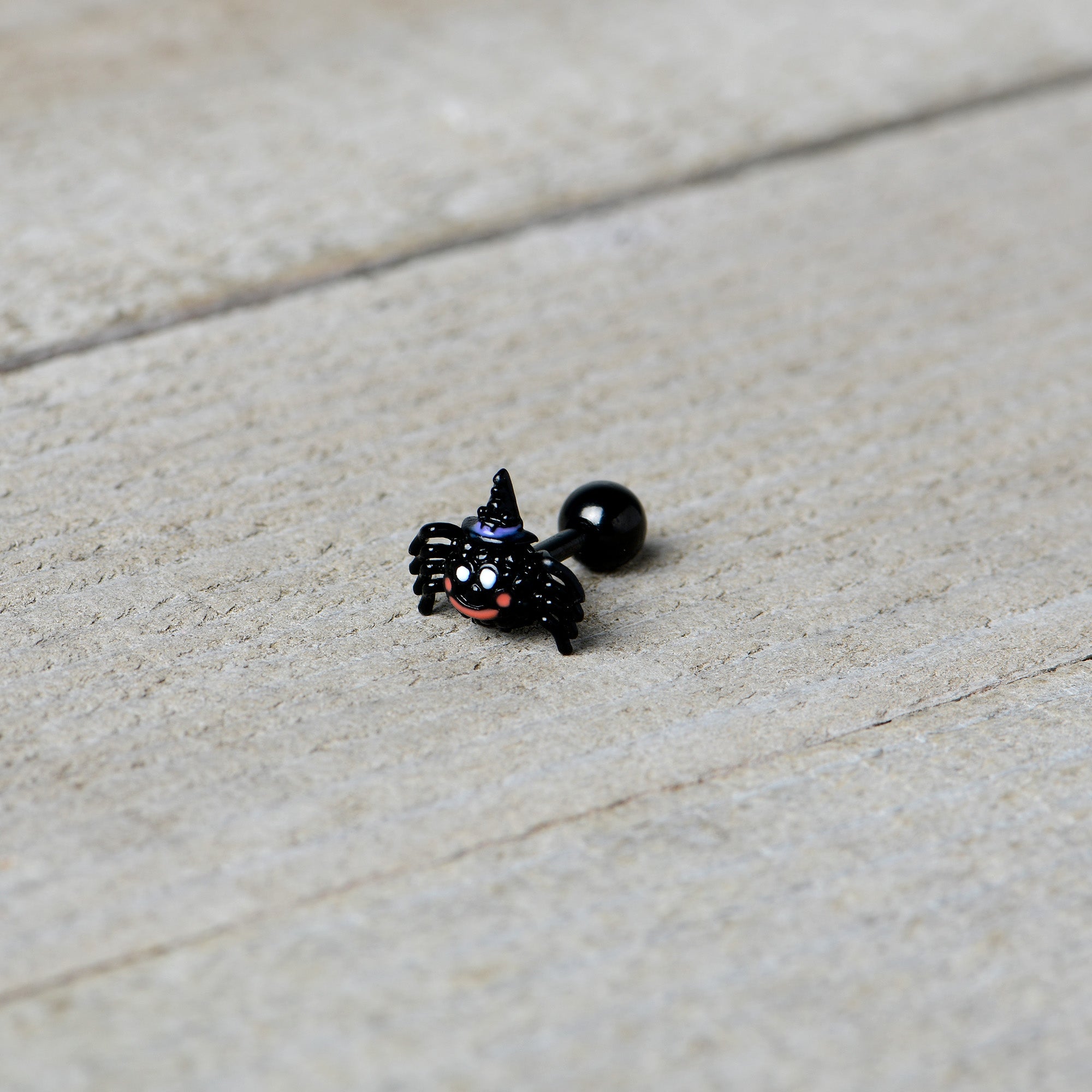 BodyCandy 16G 1/4 Black Halloween Witchy Smiling Spider Cartilage Earring — in-use photo
