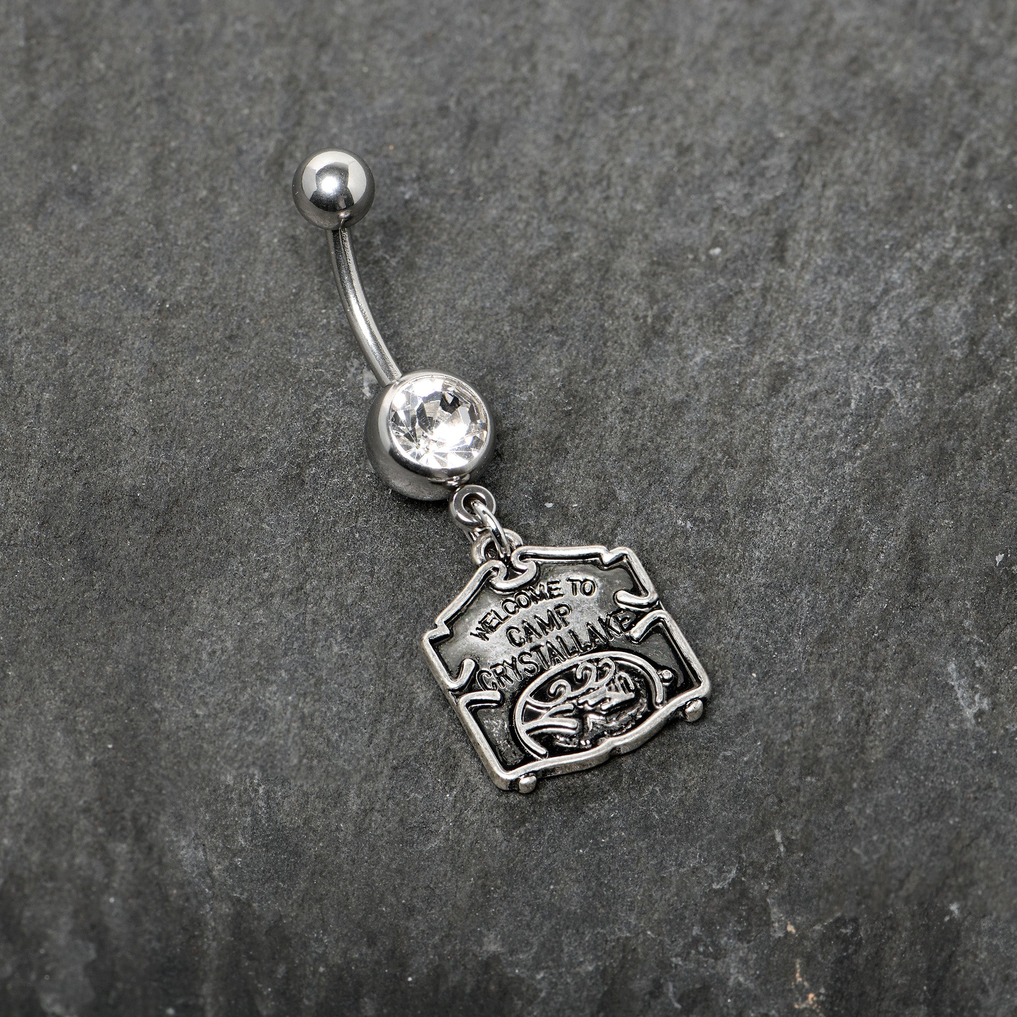 BodyCandy Officially Licensed Friday the 13th Clear Gem Camp Sign Dangle Belly Ring — side view