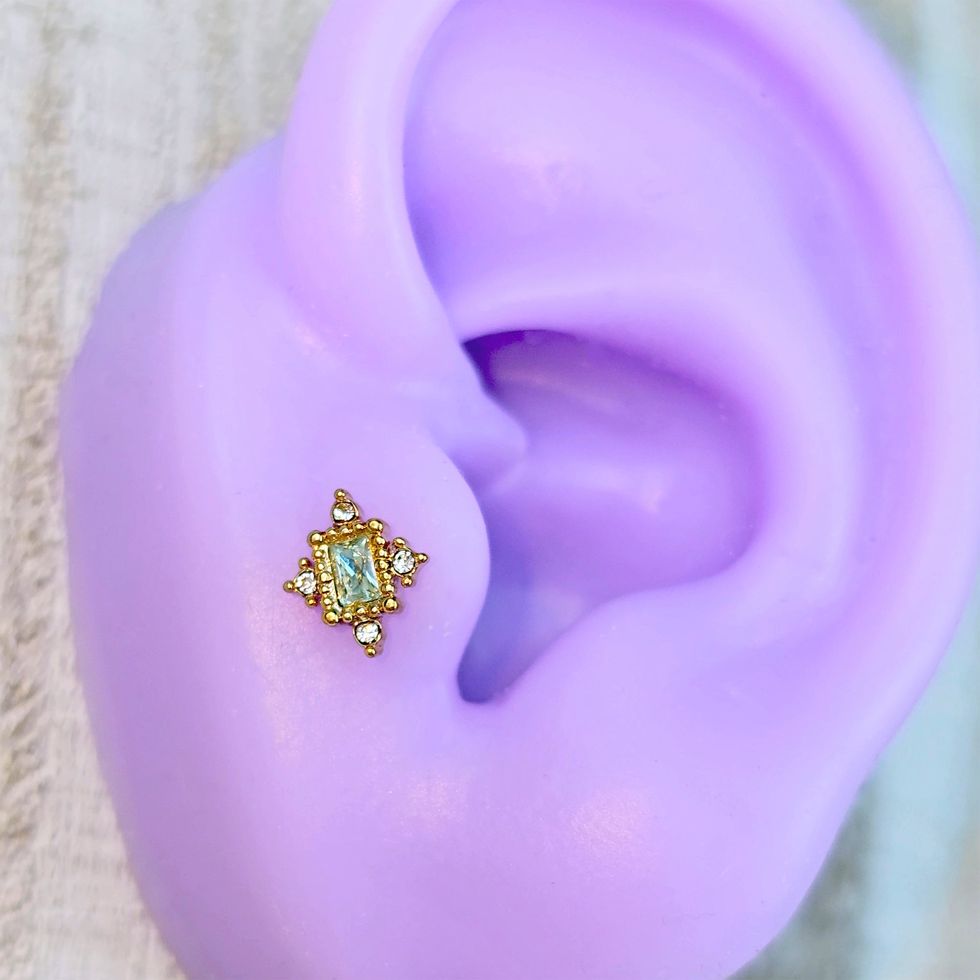 BodyCandy 16G 1/4 Clear Blue Gem Gold Tone Regal Seal Cartilage Tragus Earring — main product shot