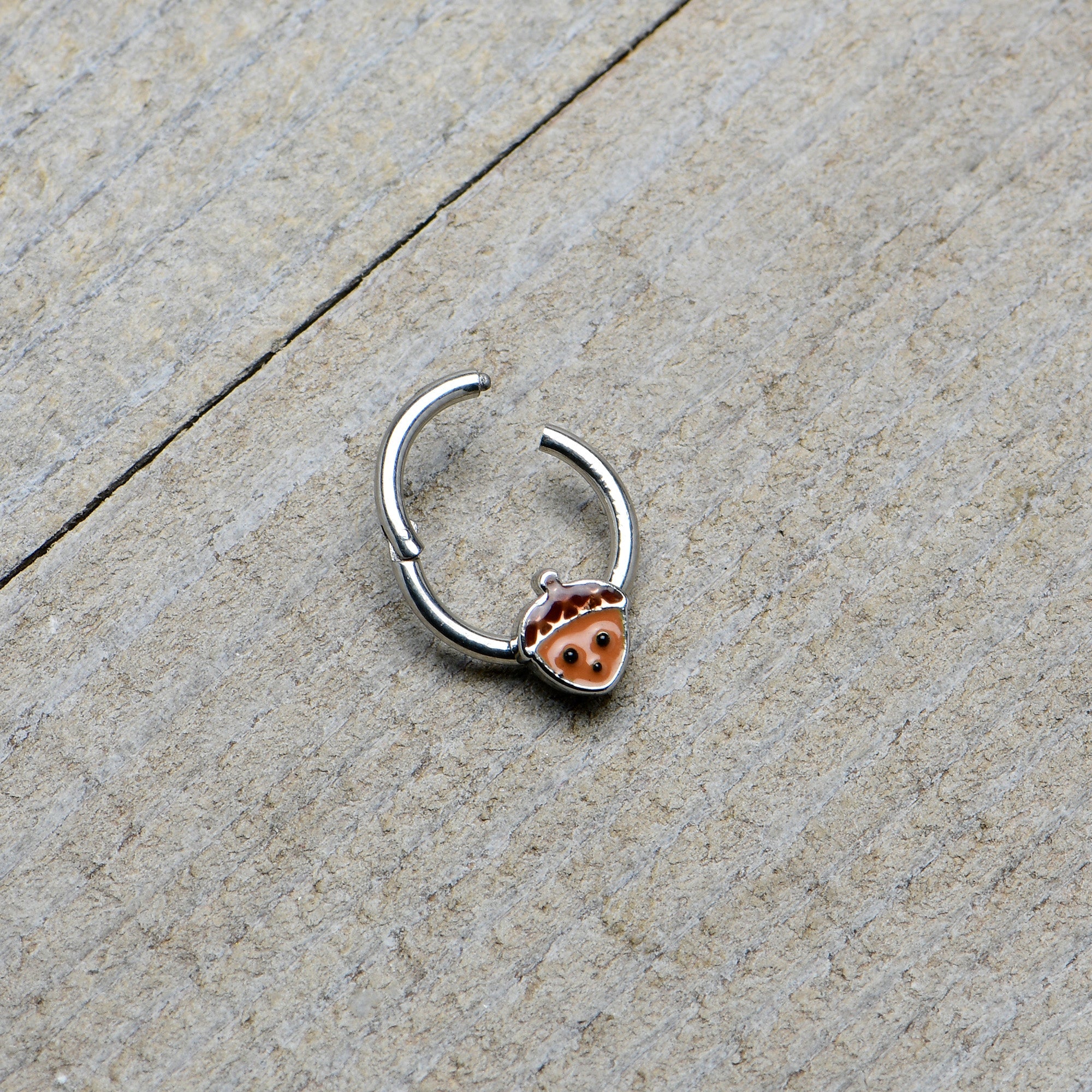 BodyCandy 16G 5/16 Fall Acorn Face Brown Autumn Hinged Segment Ring — in-use photo