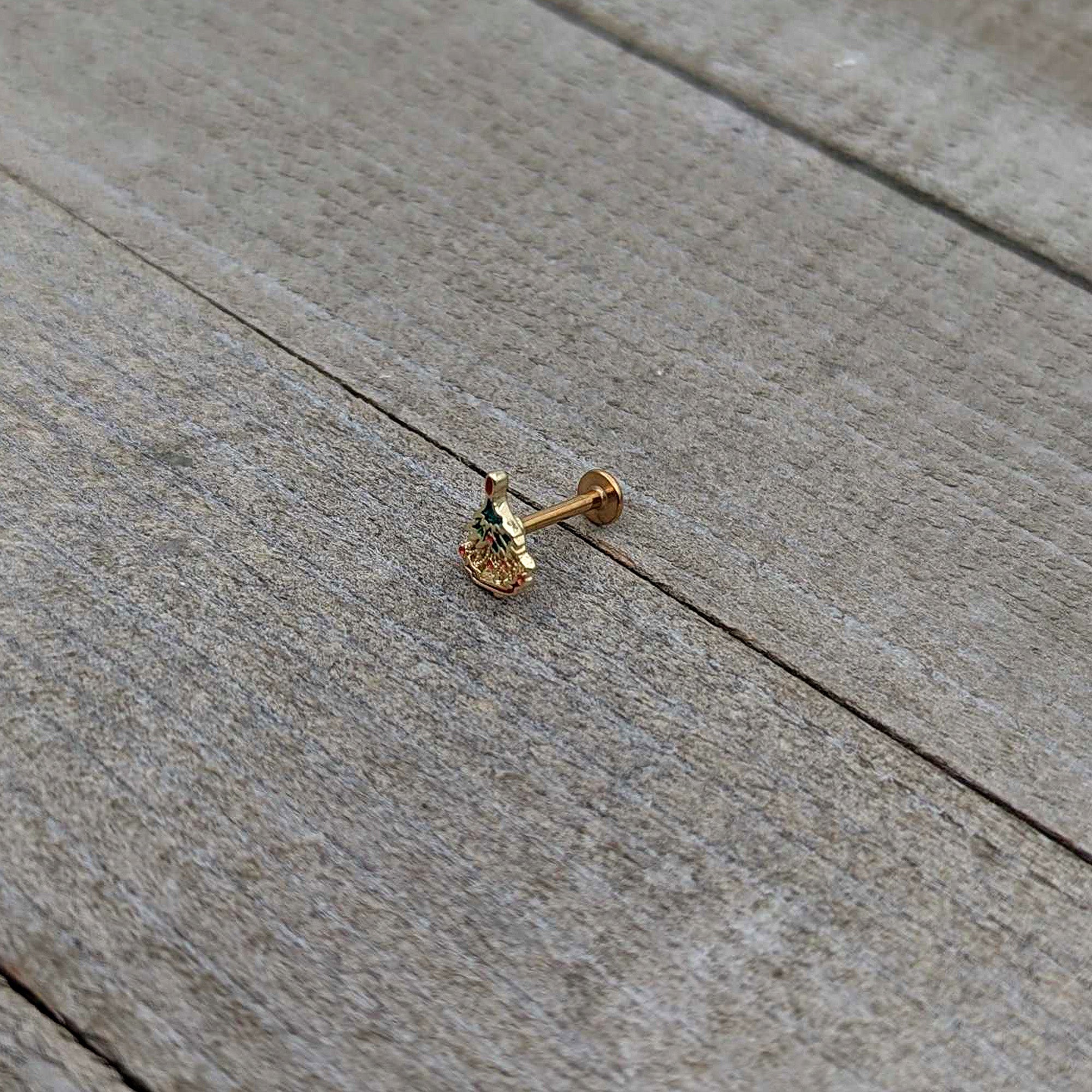 BodyCandy 16G 5/16 Red Gem Gold Tone Deco Holiday Tree Labret Monroe Tragus — in-use photo