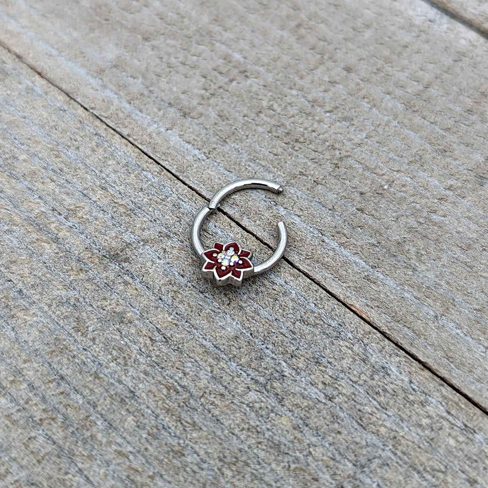 BodyCandy 16G 3/8 Aurora Gem Poinsettia Flower Festive Hinged Segment Ring — in-use photo