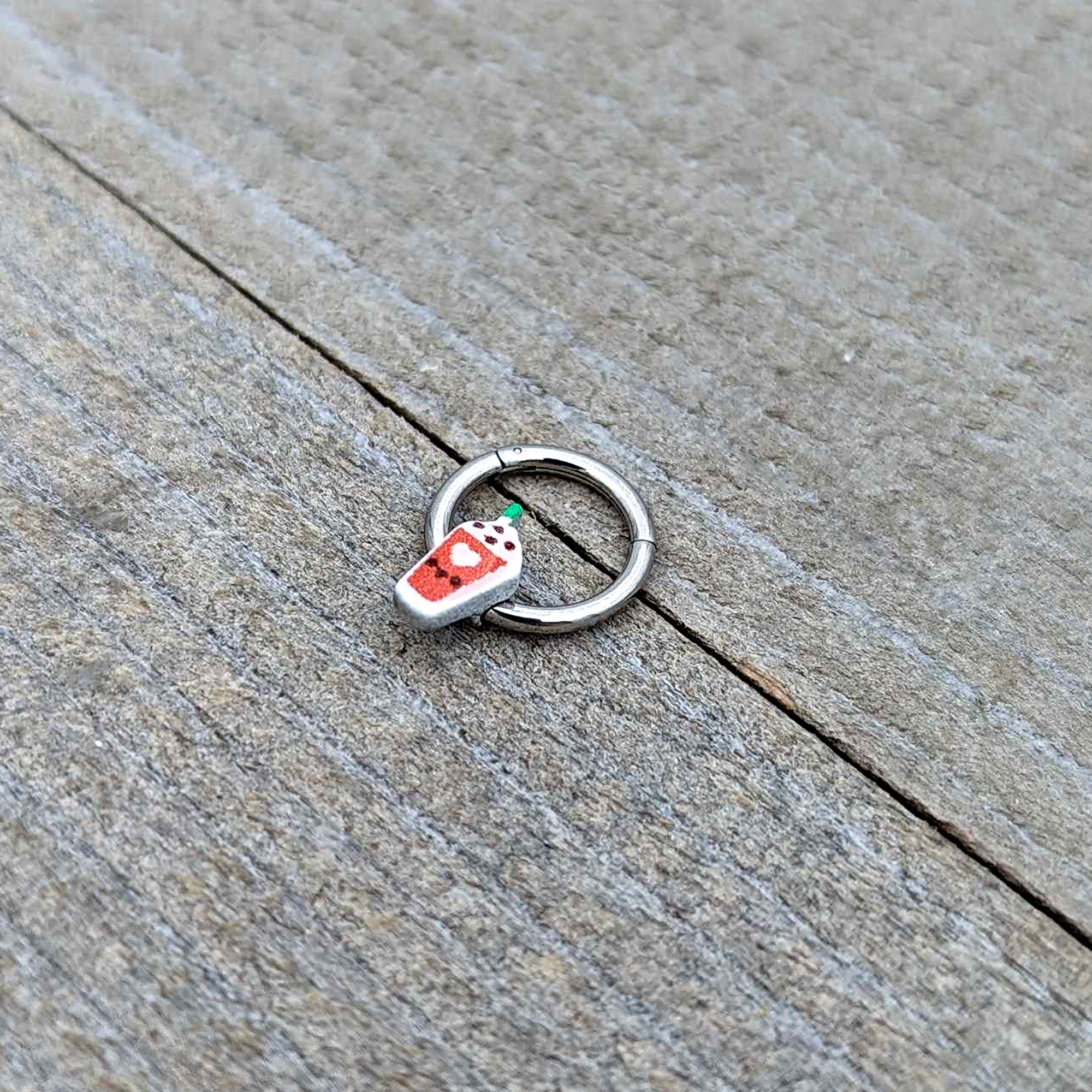 BodyCandy 16G 5/16 Sweet Pumpkin Frappe Autumn Hinged Segment Ring — in-use photo