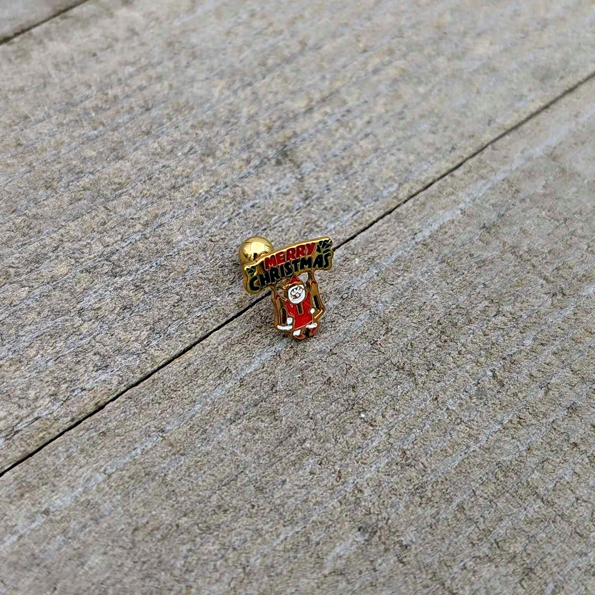 BodyCandy 16G 1/4 Gold Tone Merry Christmas Santa Inlay Cartilage Earring — in-use photo