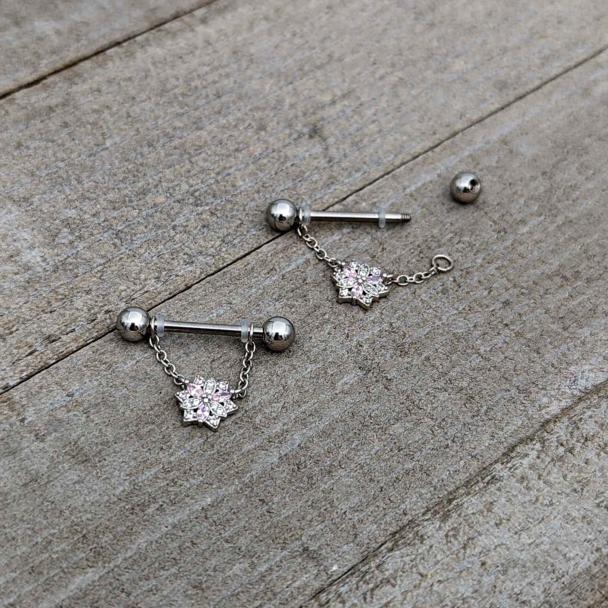 BodyCandy 14G 9/16 Pink Clear CZ Gem Snowflake Chain Dangle Nipple Ring Set — in-use photo