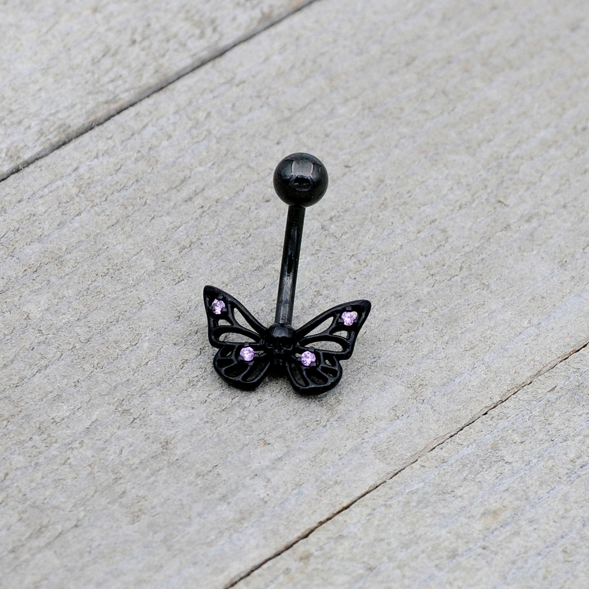 BodyCandy Purple CZ Gem Black Skull Butterfly Belly Ring — lifestyle context