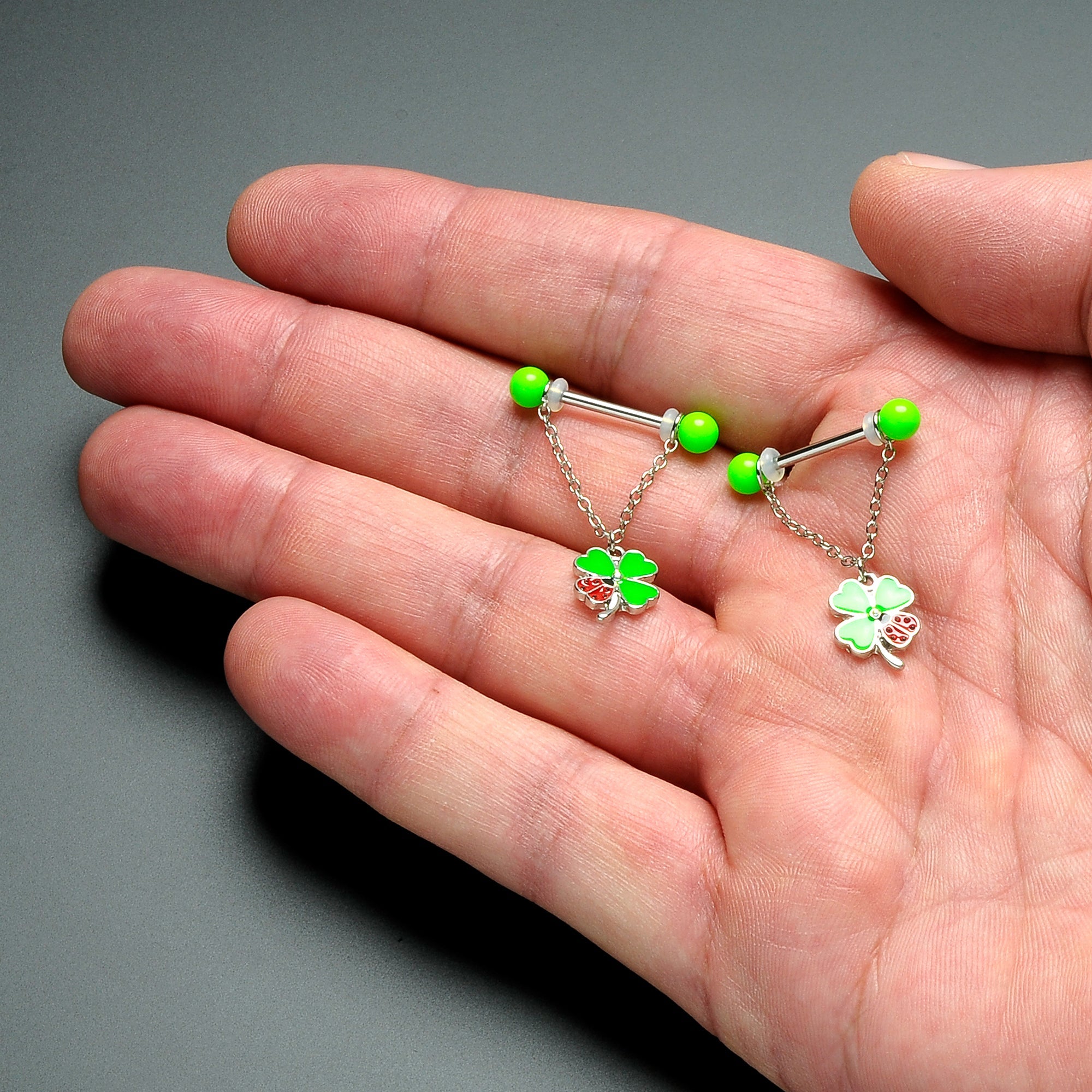 BodyCandy 14G 11/16 Ladybug Shamrock UV Glow Chain Dangle Nipple Ring Set — detail close-up