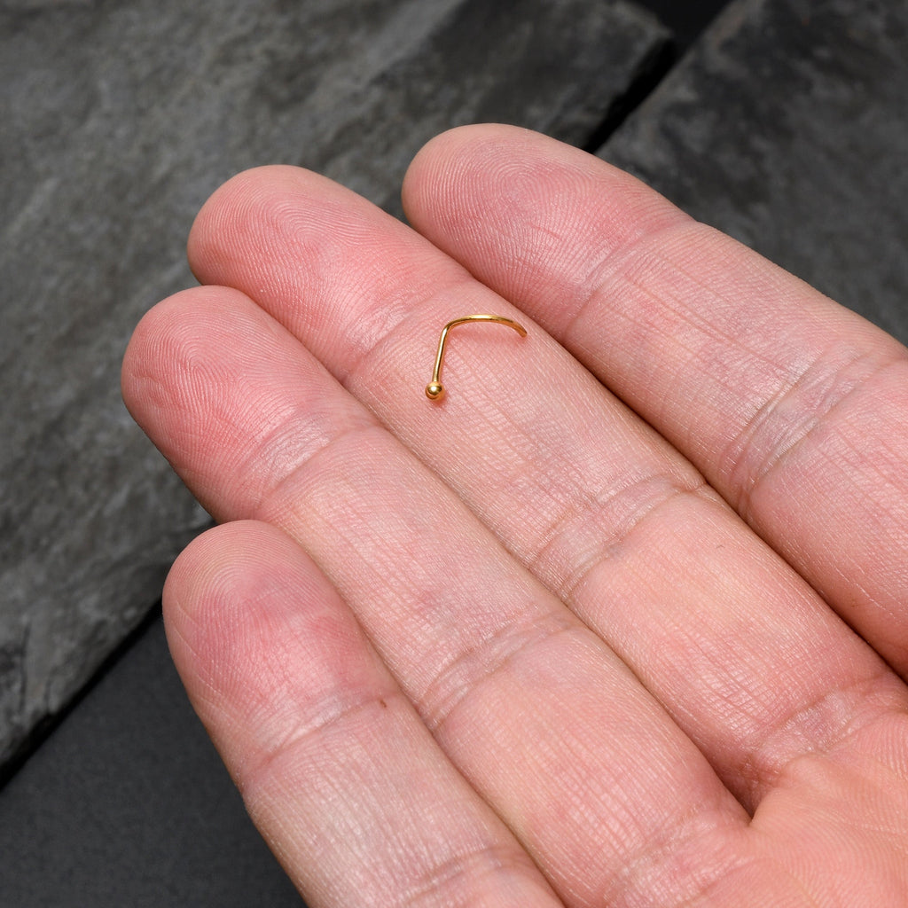 BodyCandy 20G 1/4 Gold Hue ASTM F-136 Implant Grade Titanium Ball End Left Side Nose Screw — lifestyle context