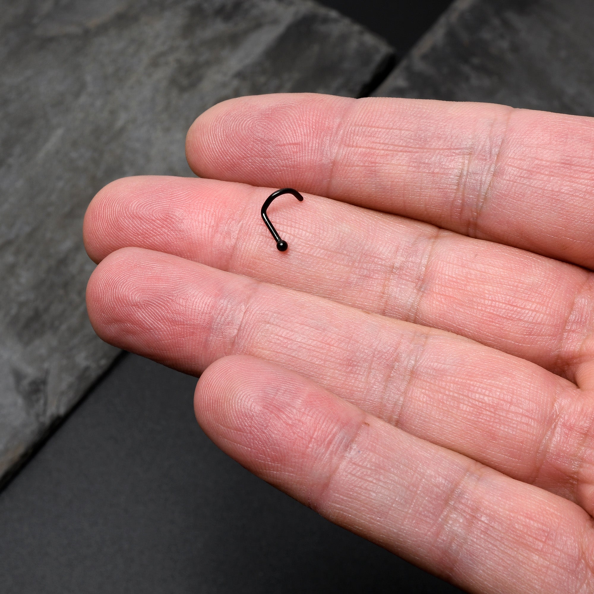 BodyCandy 18G 1/4 Black ASTM F-136 Implant Grade Titanium Ball End Left Side Nose Screw — lifestyle context