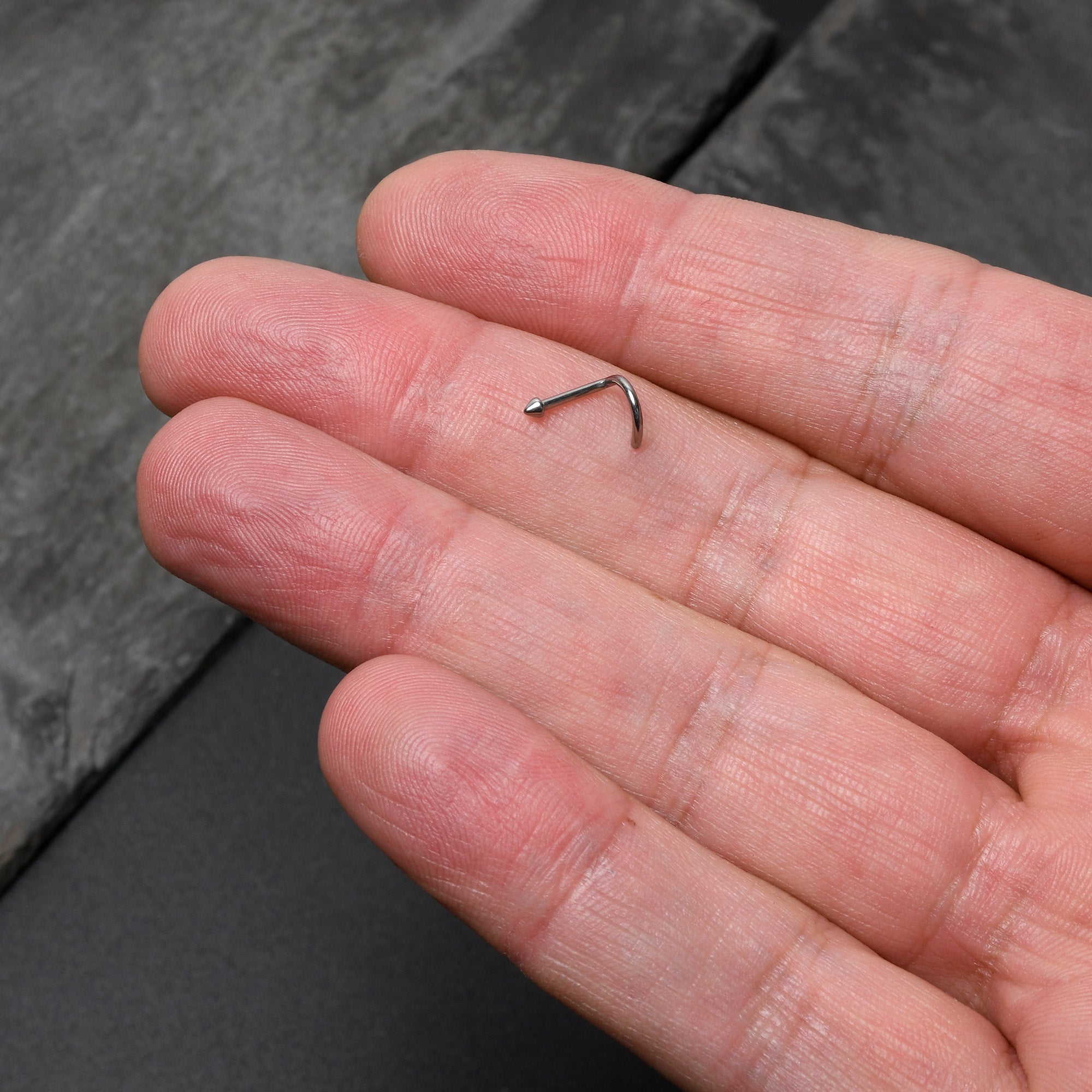 BodyCandy 18G 1/4 ASTM F-136 Implant Grade Titanium Cone End Left Side Nose Screw — lifestyle context