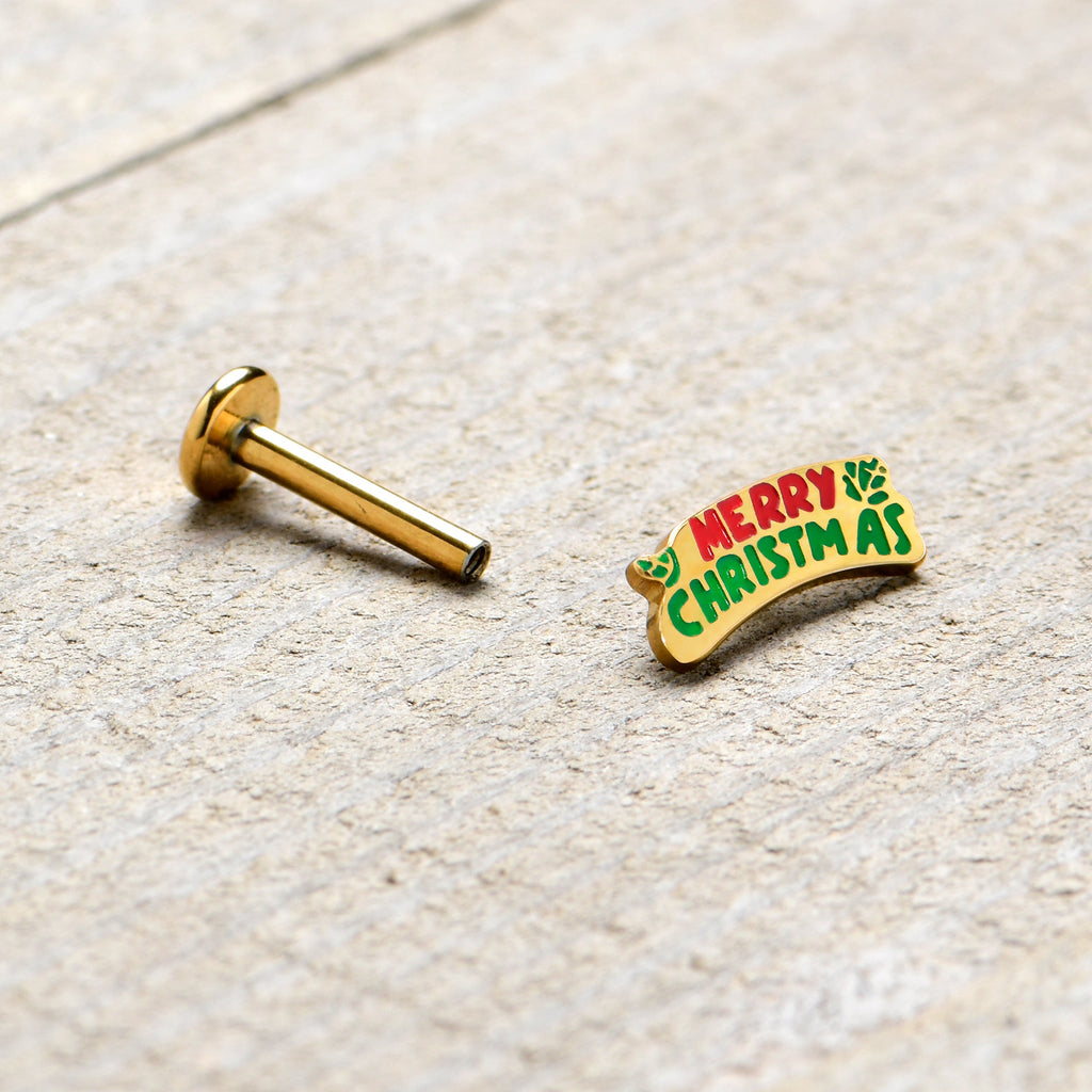 BodyCandy 16G 5/16 Gold Tone Merry Christmas Inlaid Labret Monroe Tragus — in-use photo