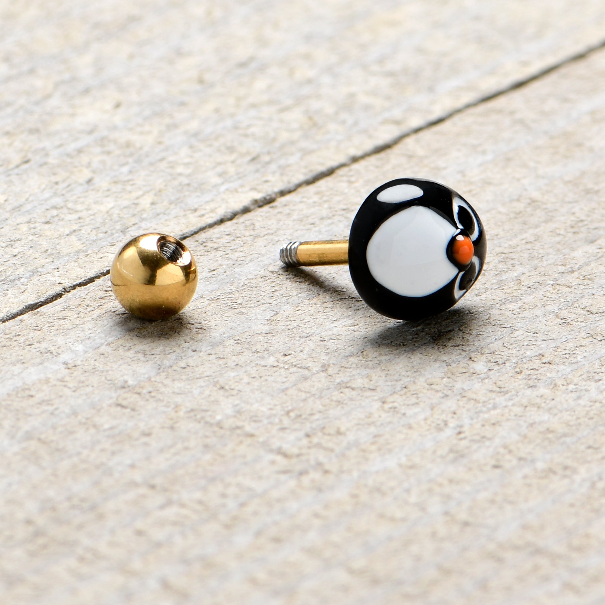 BodyCandy 16G 1/4 Gold Tone Round Penguin Face Holiday Cartilage Earring — side view