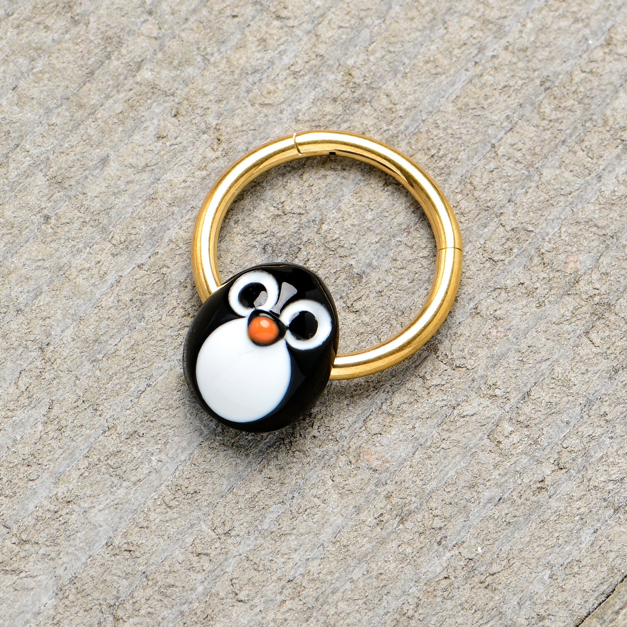 BodyCandy 16G 3/8 Gold Tone Round Penguin Face Holiday Hinged Segment Ring — lifestyle context