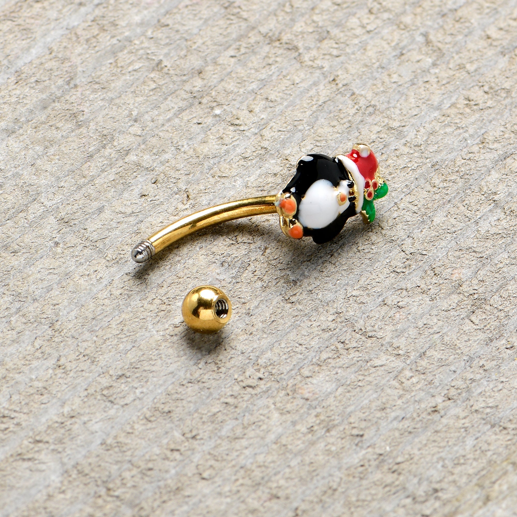 BodyCandy 16G 5/16 Gold Tone Holly Hat Penguin Holiday Curved Eyebrow Ring — lifestyle context