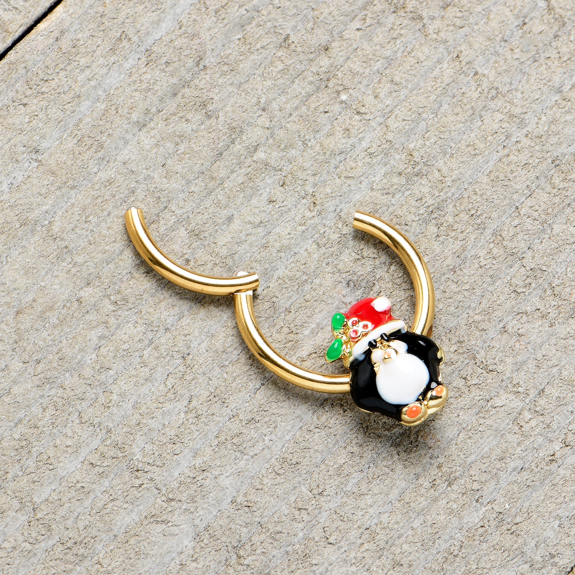 BodyCandy 16G 3/8 Gold Tone Holly Hat Penguin Holiday Hinged Segment Ring — in-use photo