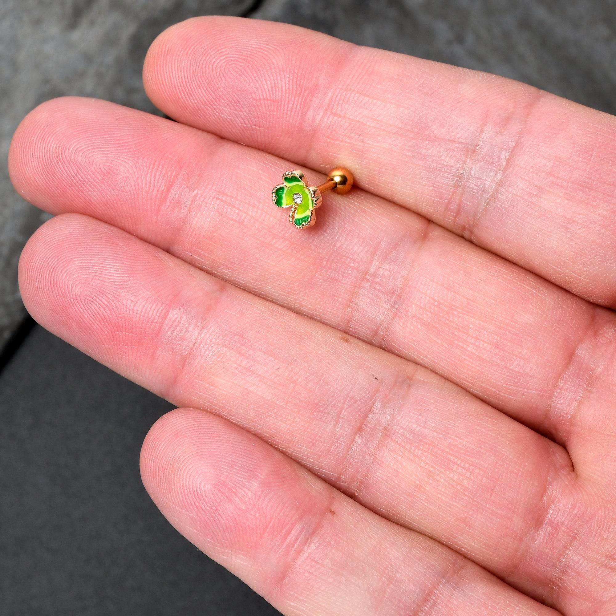 BodyCandy 16G 1/4 Clear Gem Gold Hue Lucky Shamrock Cartilage Tragus Earring — detail close-up