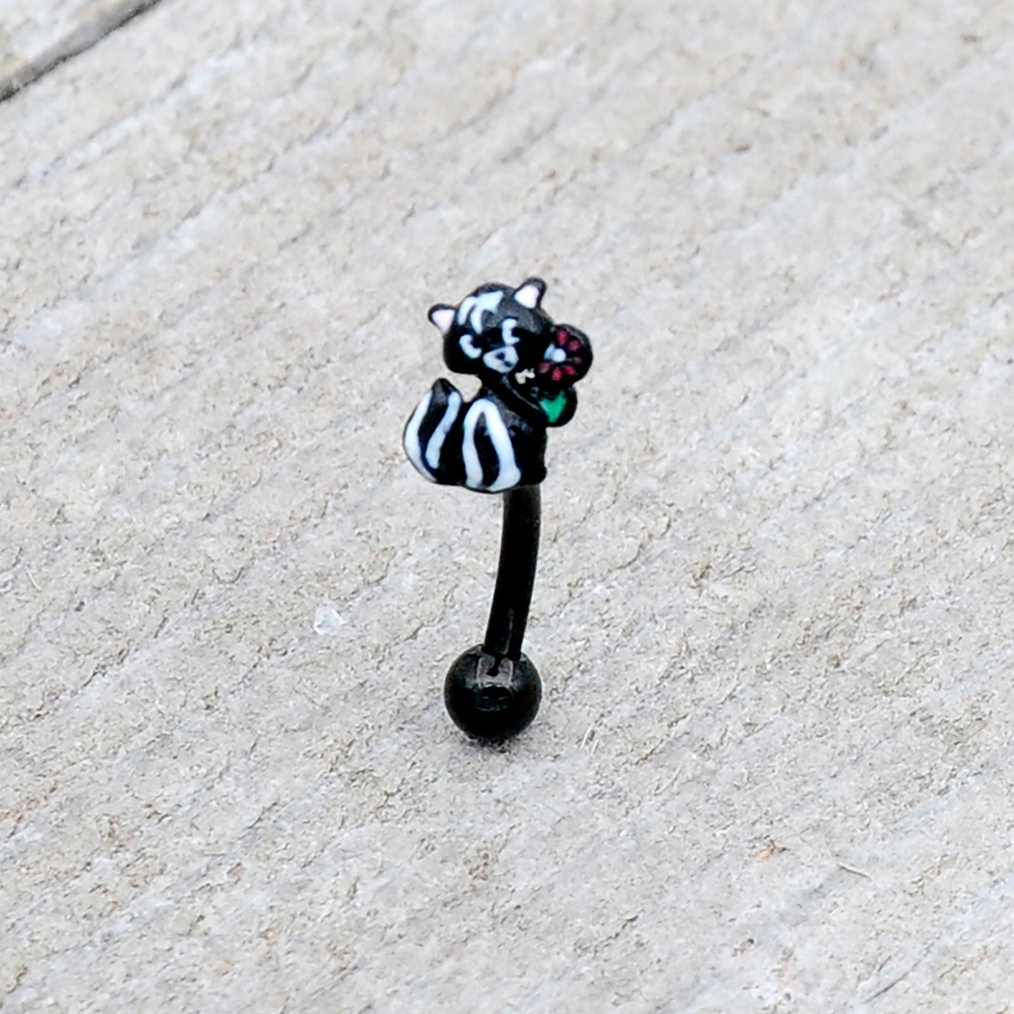 BodyCandy 16G 5/16 Black Funky Skunk Curved Eyebrow Ring — lifestyle context