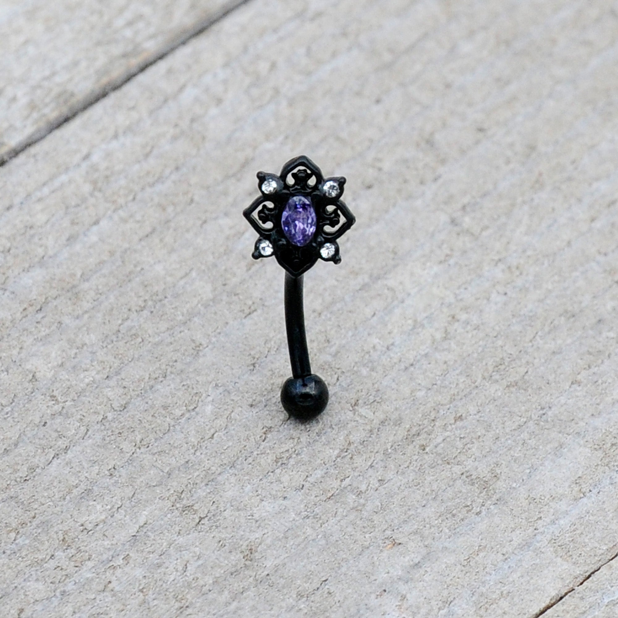 BodyCandy 16G 5/16 Purple Gem Black Scrolling Hearts Curved Eyebrow Ring — lifestyle context