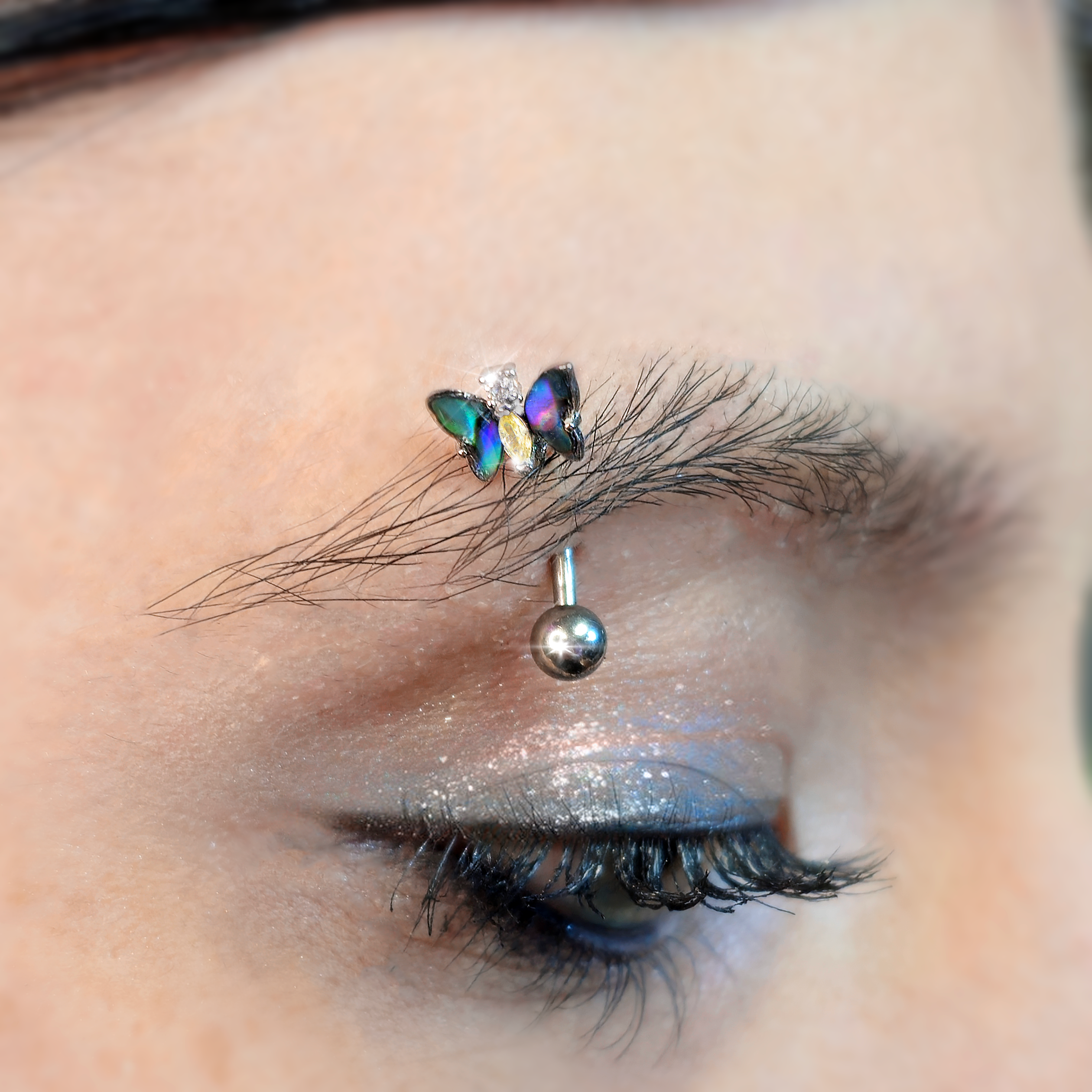 BodyCandy 16G 5/16 Yellow Clear Gem Dark Butterfly Curved Eyebrow Ring — detail close-up