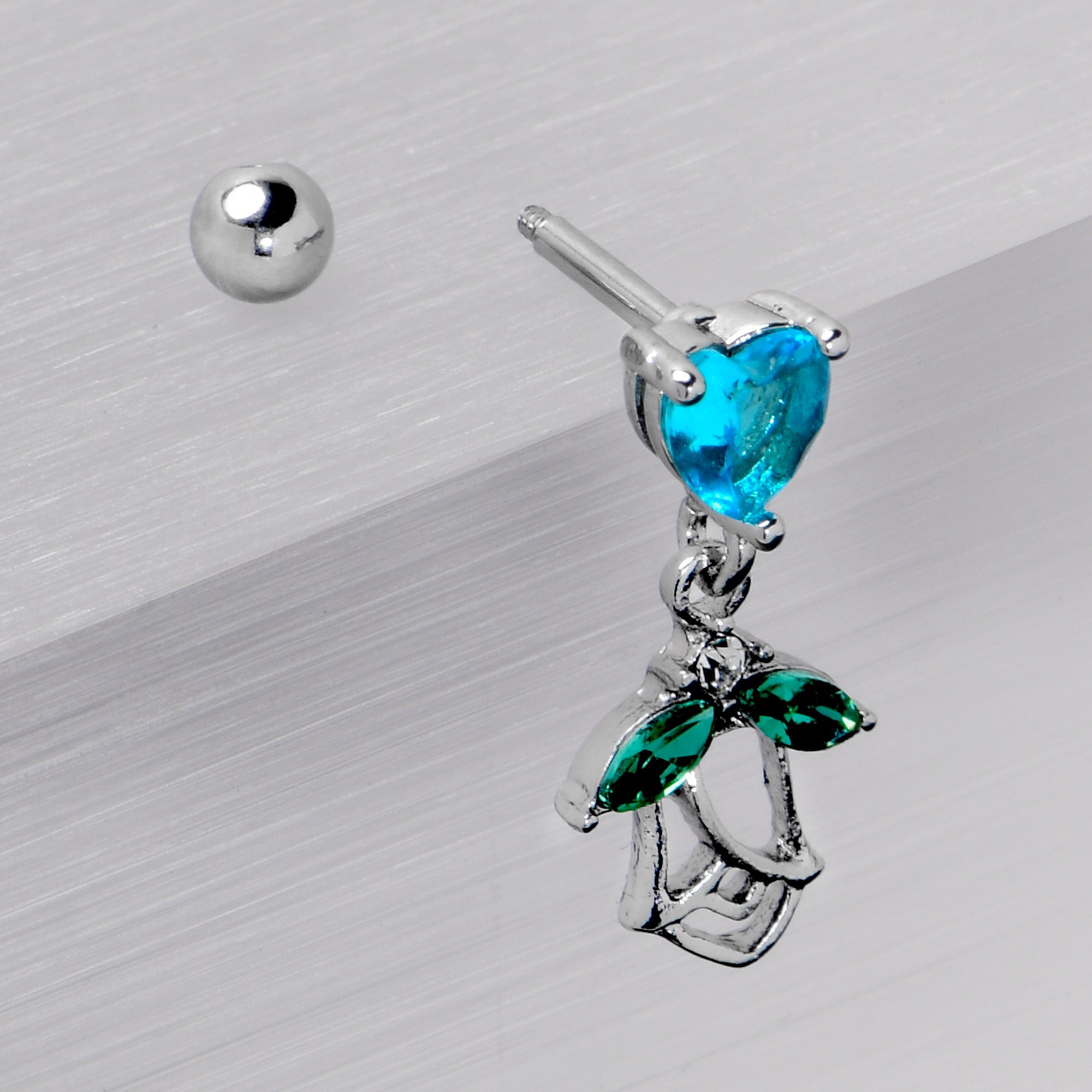BodyCandy 16G 1/4 Blue CZ Gem Heart And Rose Dangle Cartilage Earring — in-use photo