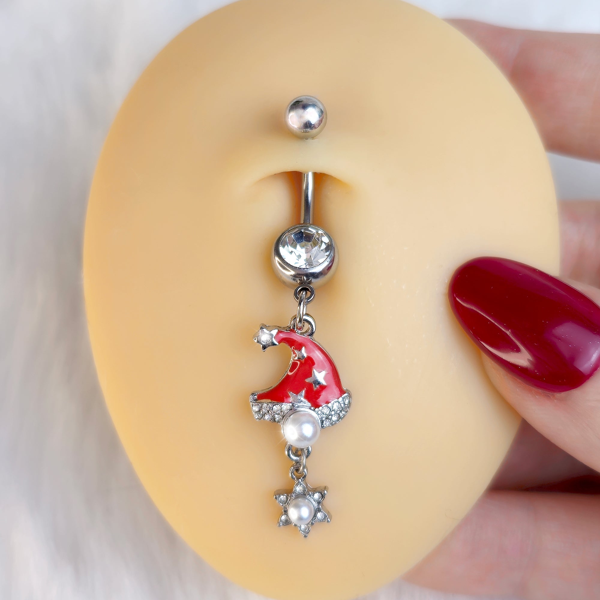 BodyCandy Clear Gem Santa Hat Stars Red Dangle Belly Ring — detail close-up