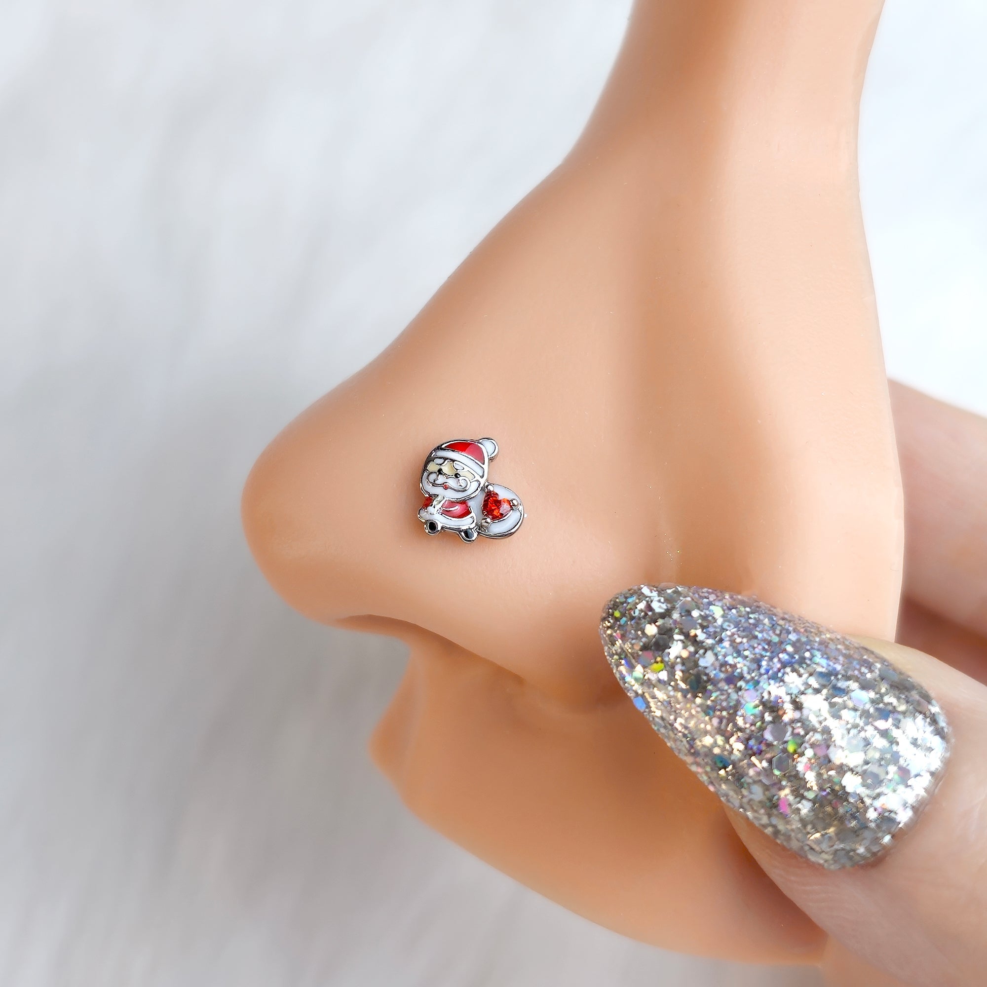 BodyCandy 20G 7mm Red Gem Santa Bag Heart Holiday Left Side Nose Screw — detail close-up