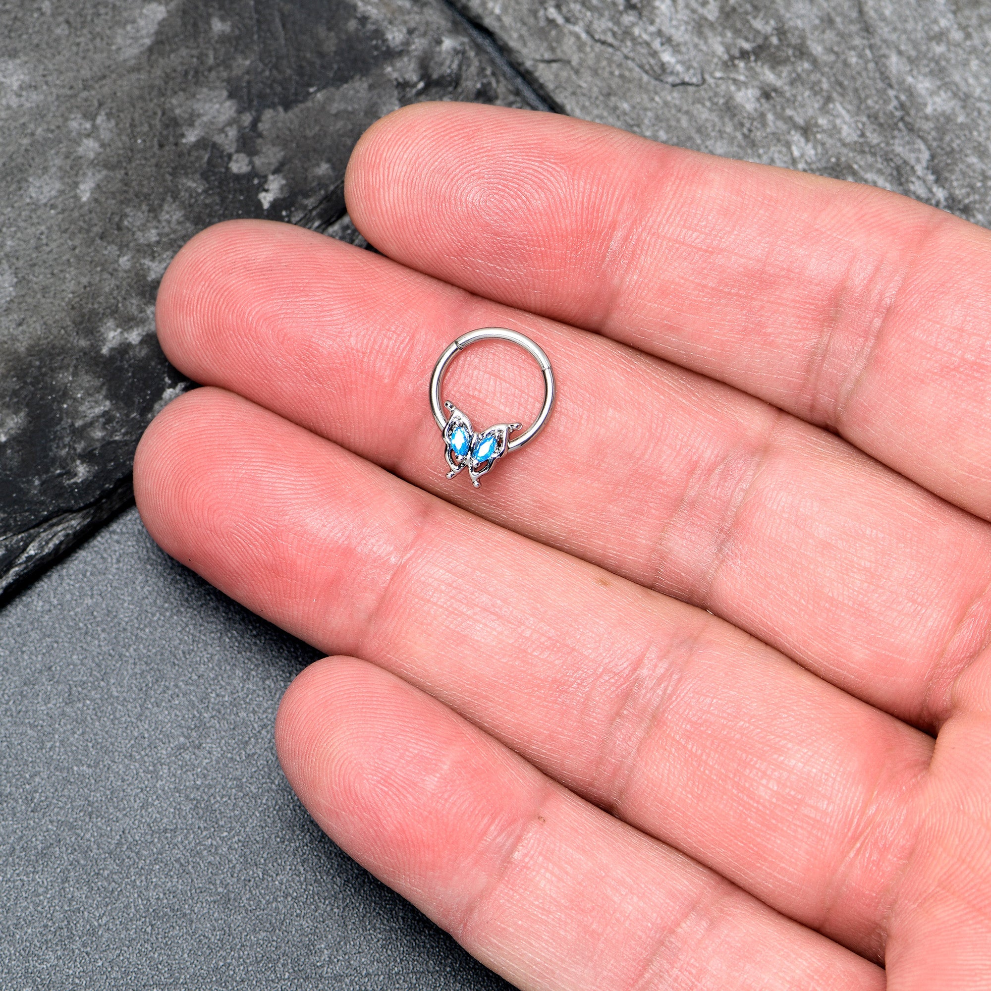 BodyCandy 16G 3/8 Blue Gem Fancy Fab Butterfly Hinged Segment Ring — lifestyle context