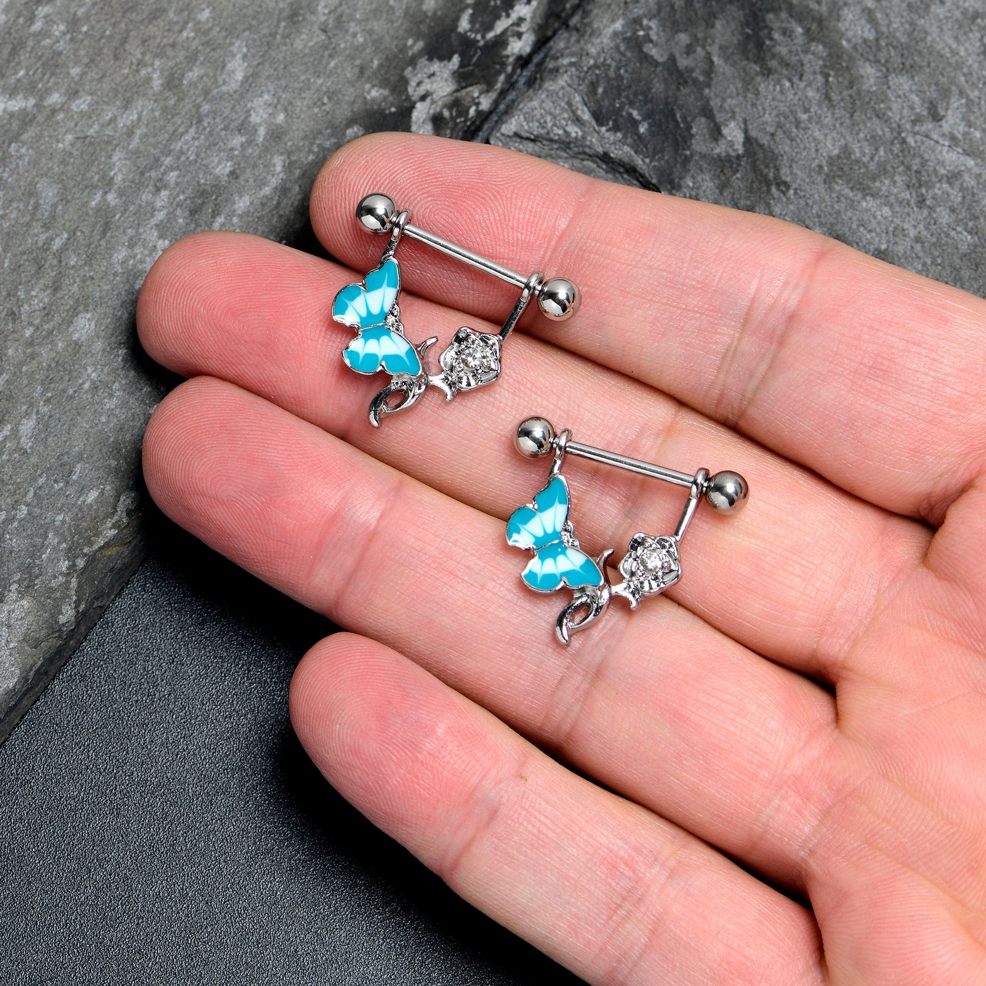 BodyCandy 14G 9/16 Butterfly Blue Rose Flower Dangle Nipple Ring Set — lifestyle context
