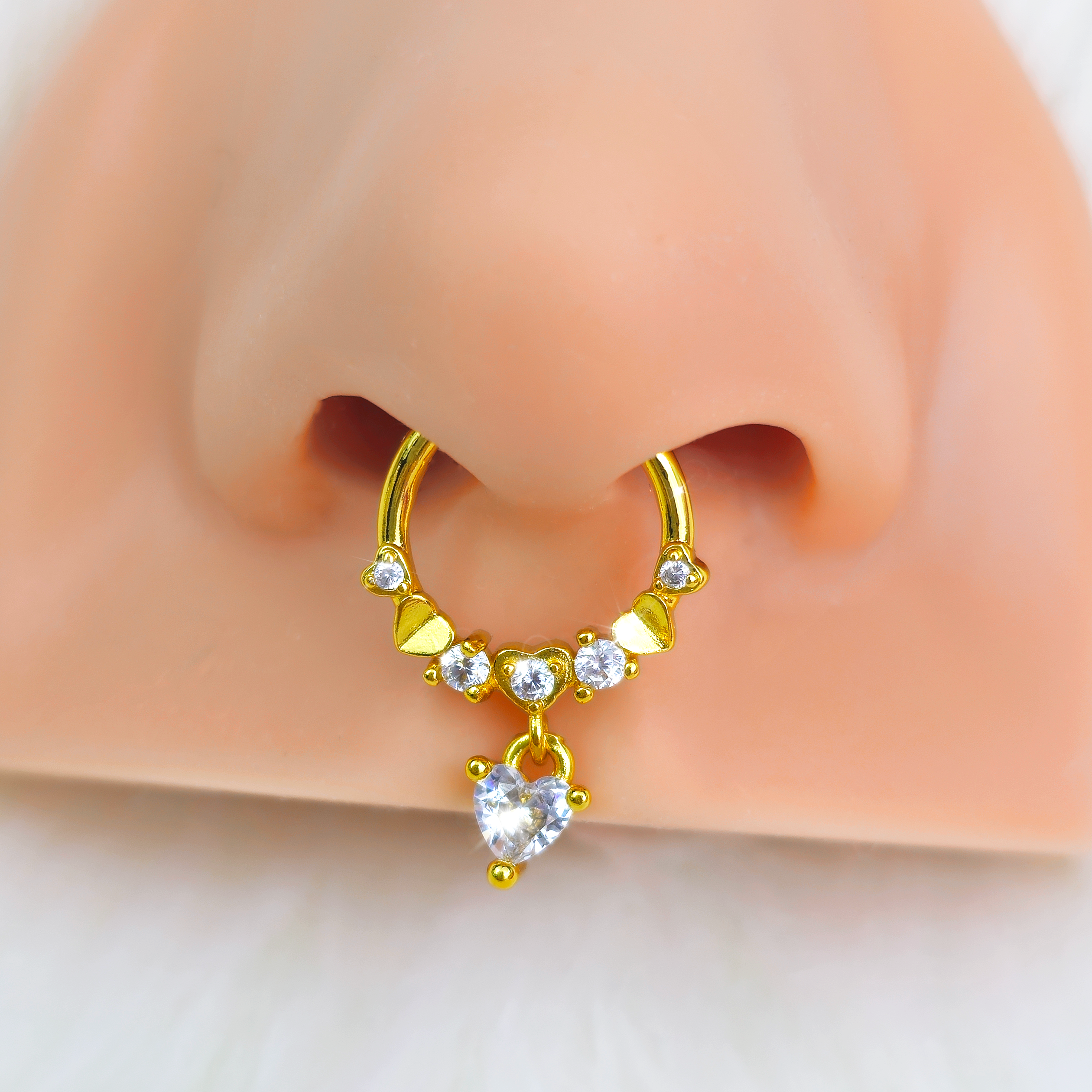 BodyCandy 16G 3/8 Clear CZ Gem Gold Tone Love Heart Dangle Hinged Segment Ring — detail close-up