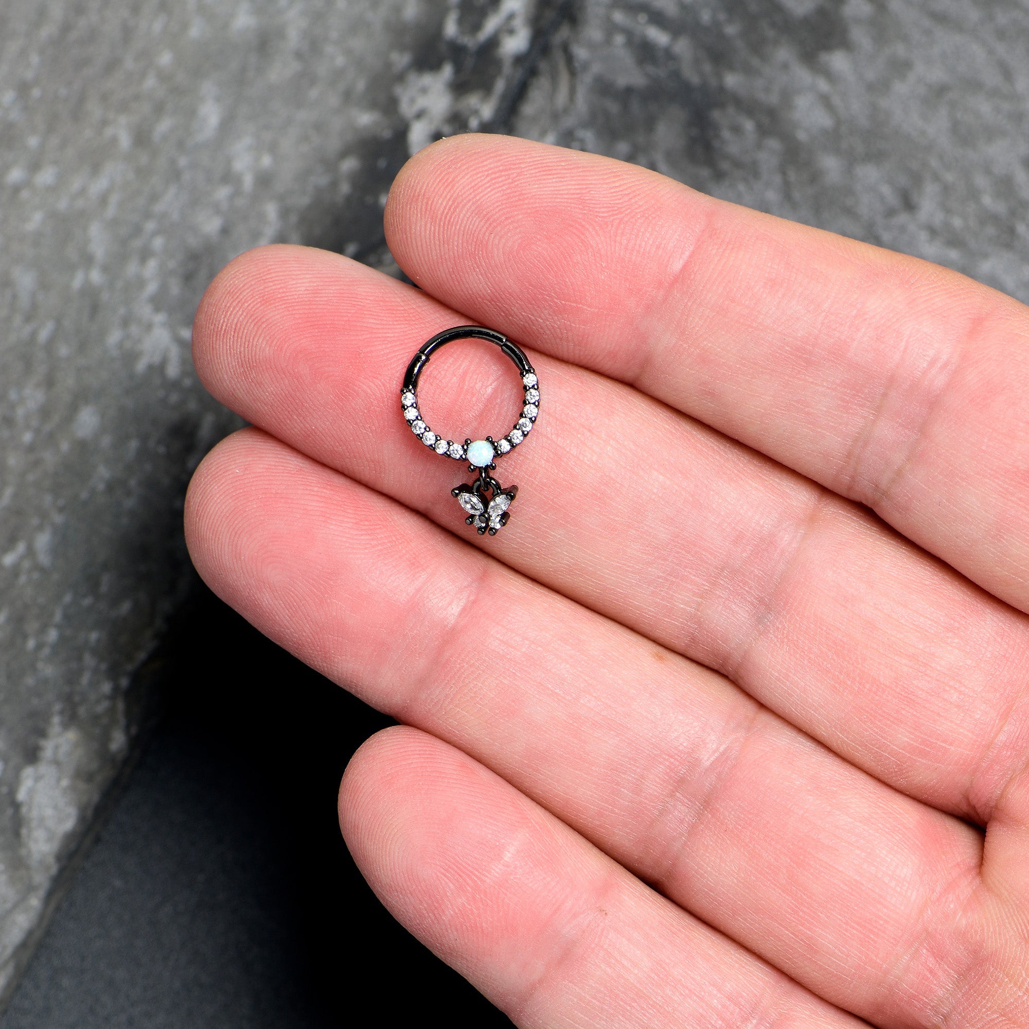 BodyCandy 16G 3/8 Blue Synthetic Opal Black Butterfly Hinged Segment Ring — lifestyle context