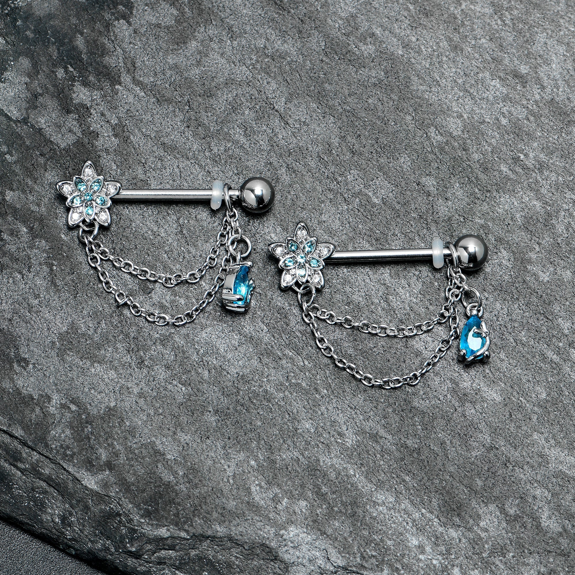 BodyCandy 14G 9/16 Blue CZ Gem Snowflake Flower Chain Dangle Nipple Ring Set — lifestyle context