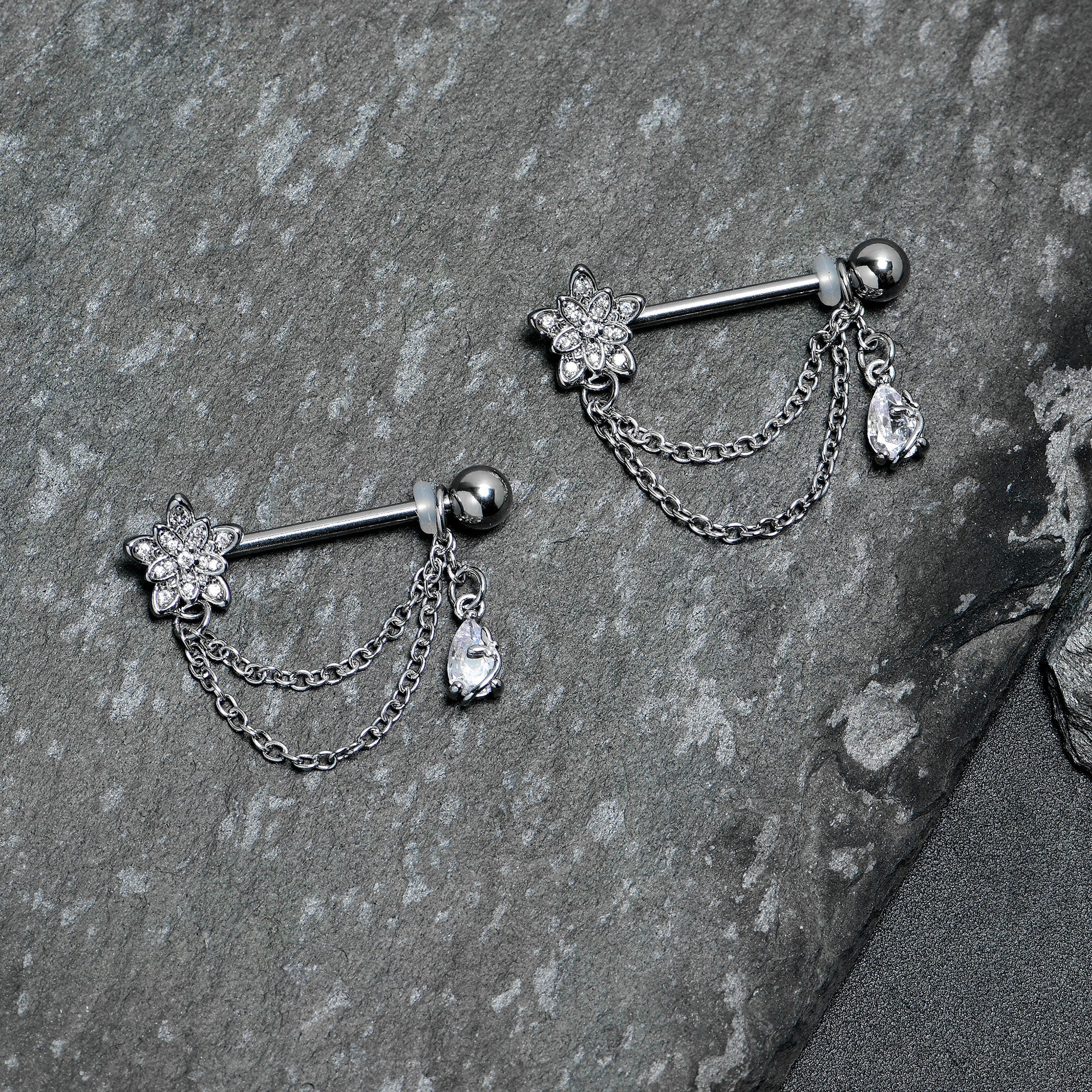 BodyCandy 14G 9/16 Clear CZ Gem Snowflake Flower Chain Dangle Nipple Ring Set — lifestyle context