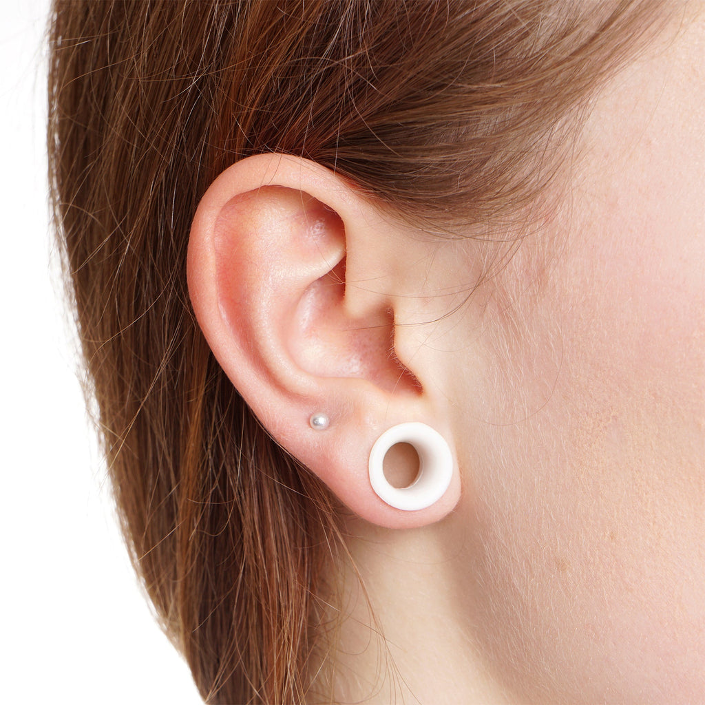 BodyCandy 14G to 1/2 White Acrylic 54 Piece Ear Stretching Kit with Jojoba Oil — detail close-up