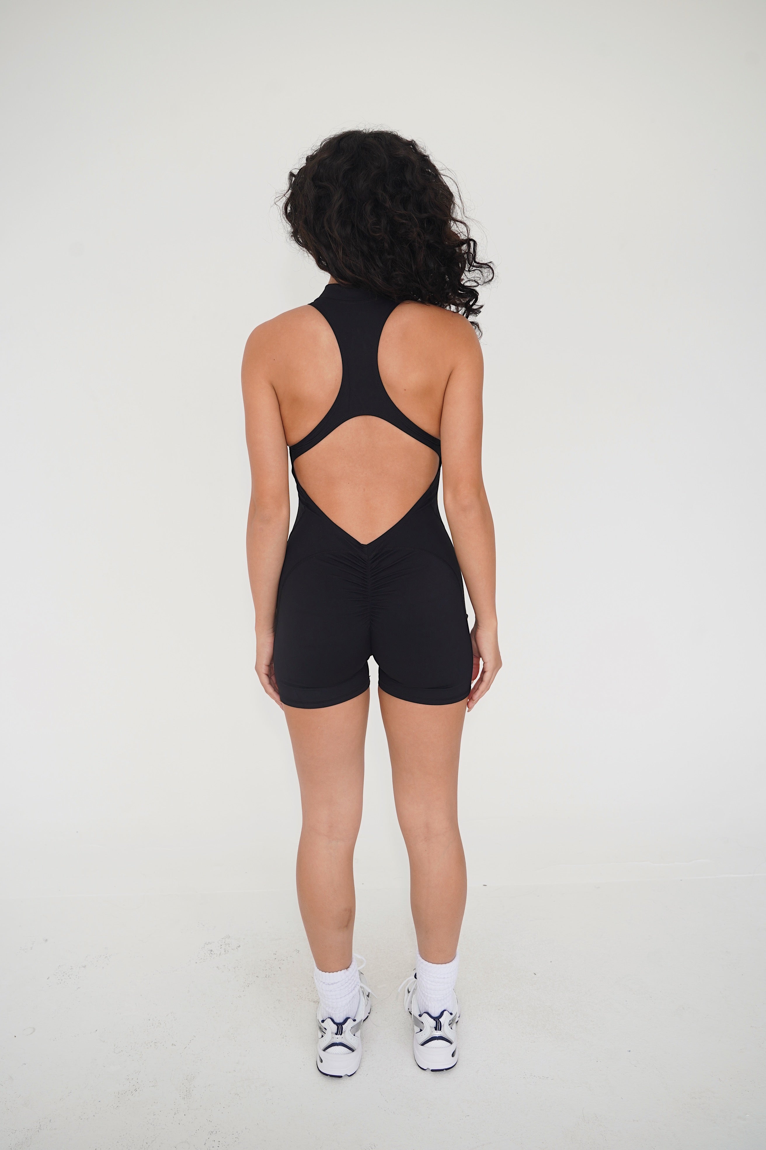 KIMITH BRAND I am Limitless Zipper Bodysuit in Black — detail shot 8