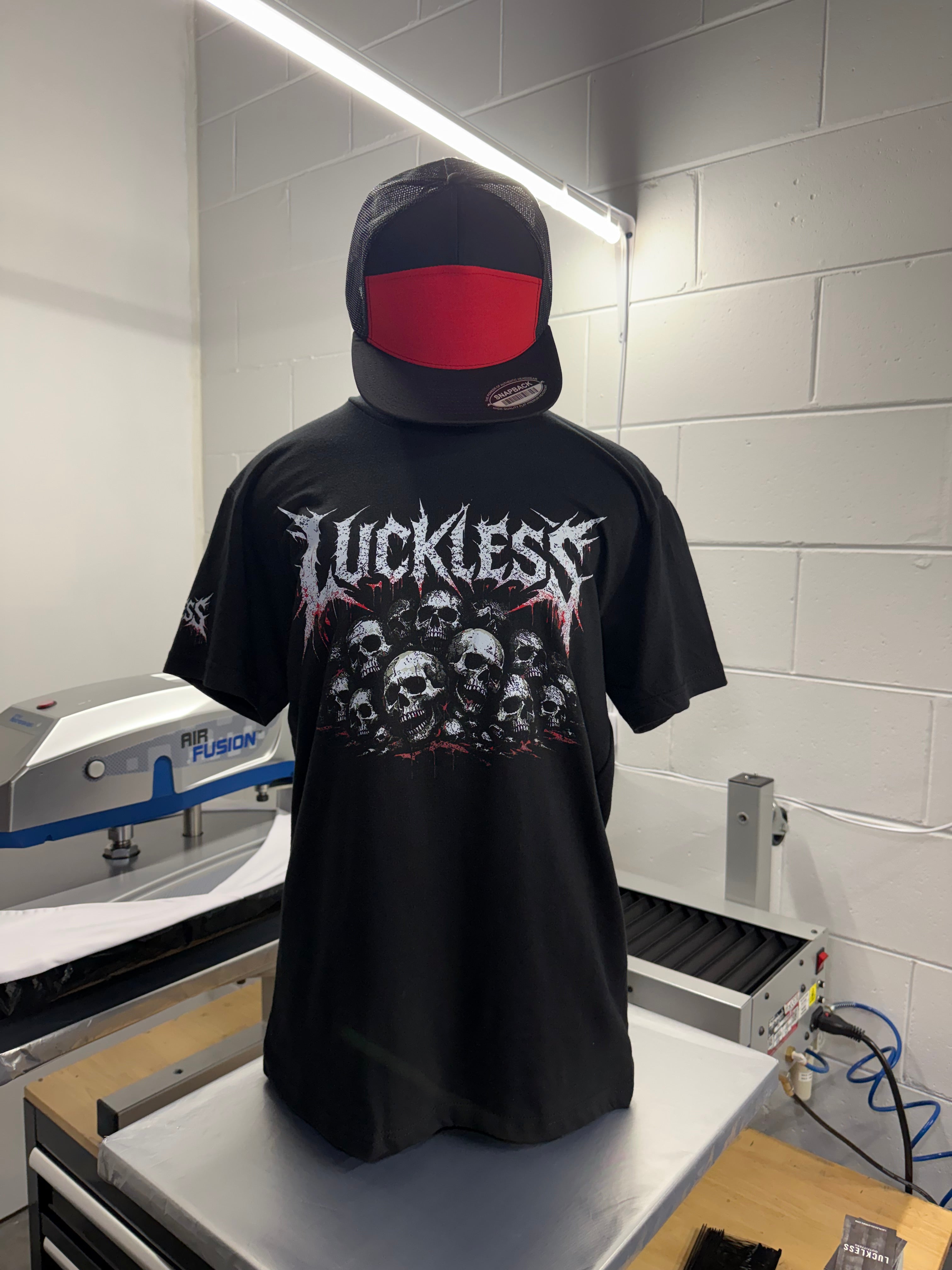 Luckless Outfitters Pile of Skulls Tee — lifestyle context
