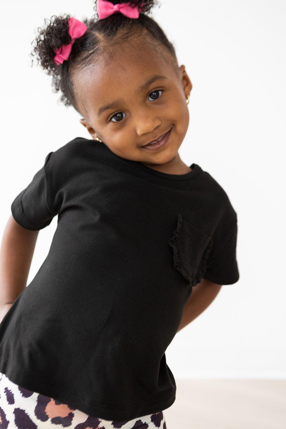 Mila & Rose ® Black Ruffle Pocket Tee — detail close-up