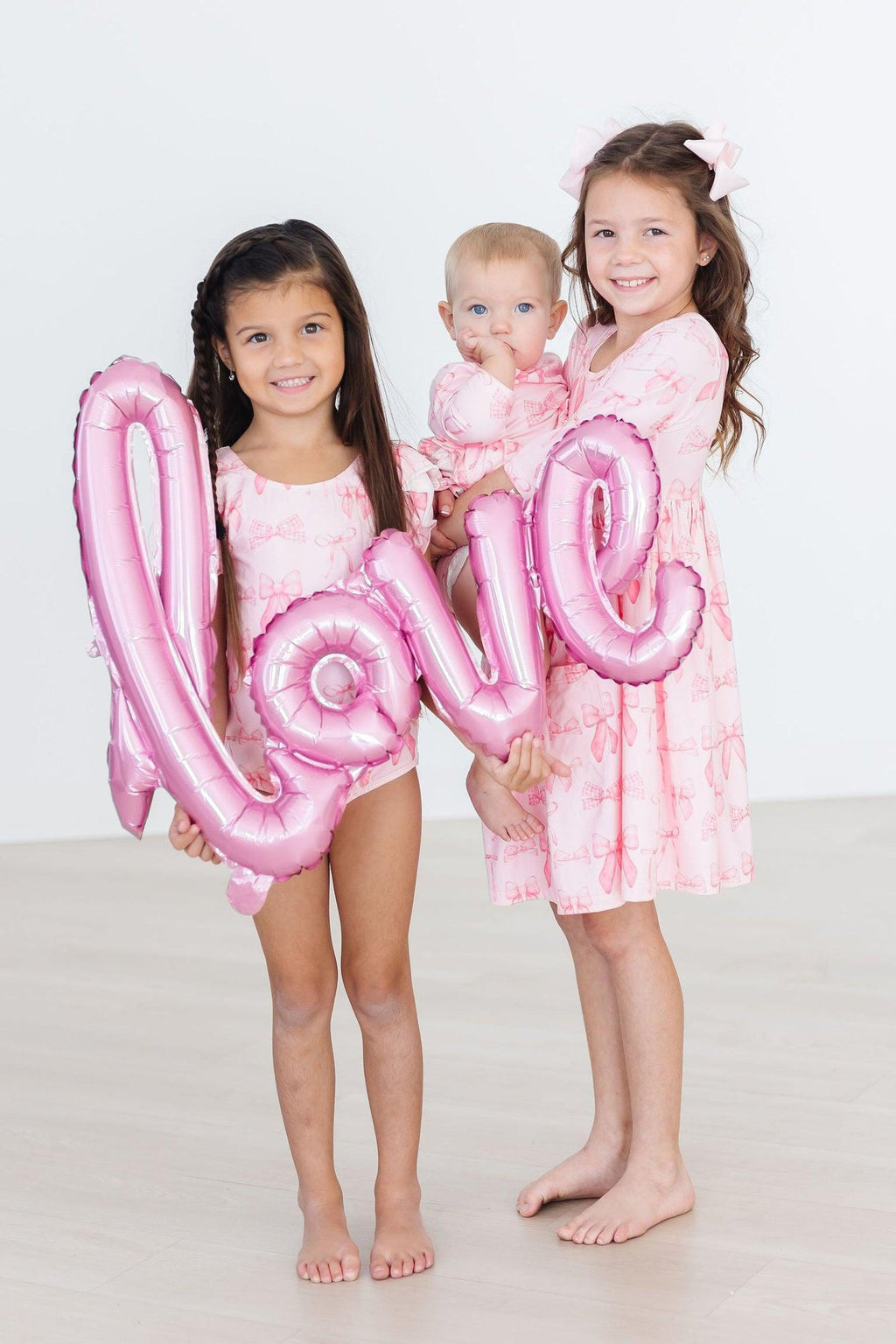 Mila & Rose ® Blushing Bows 3/4 Sleeve Twirl Bodysuit — detail close-up