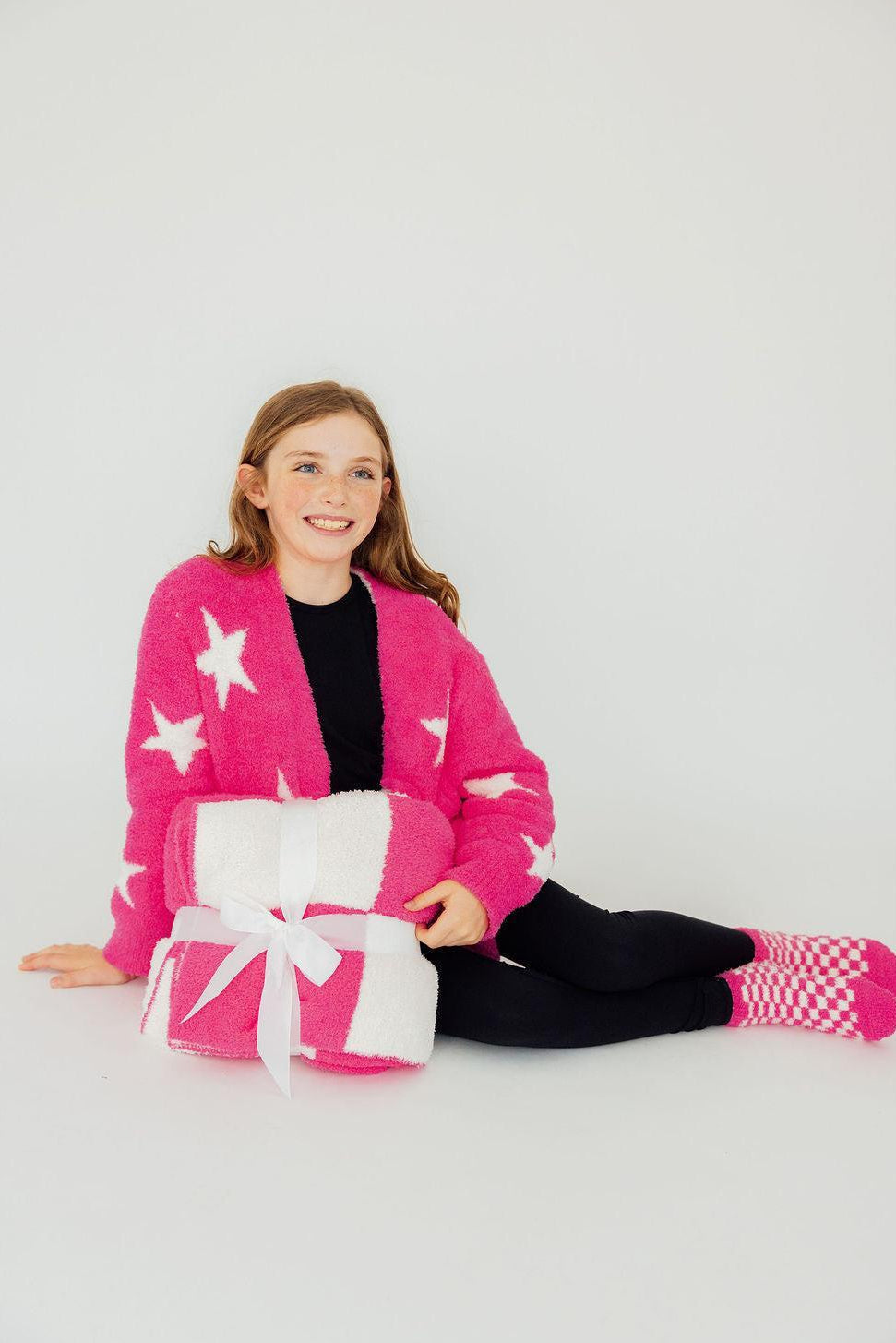 Mila & Rose ® Bright Pink Checker Bow Cozy Blanket — lifestyle context