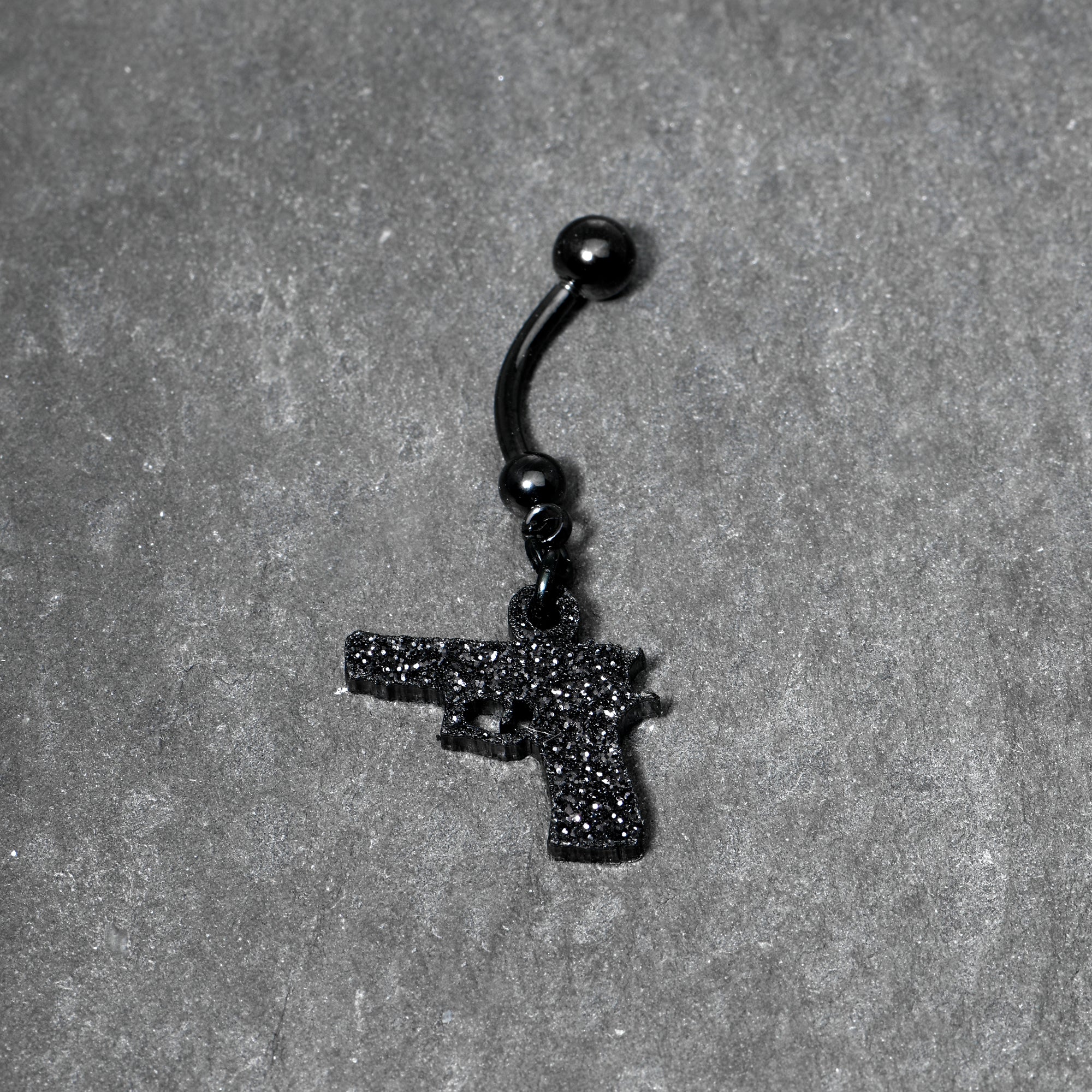 BodyCandy Jet Black Glitter Gun Dangle Belly Ring — lifestyle context