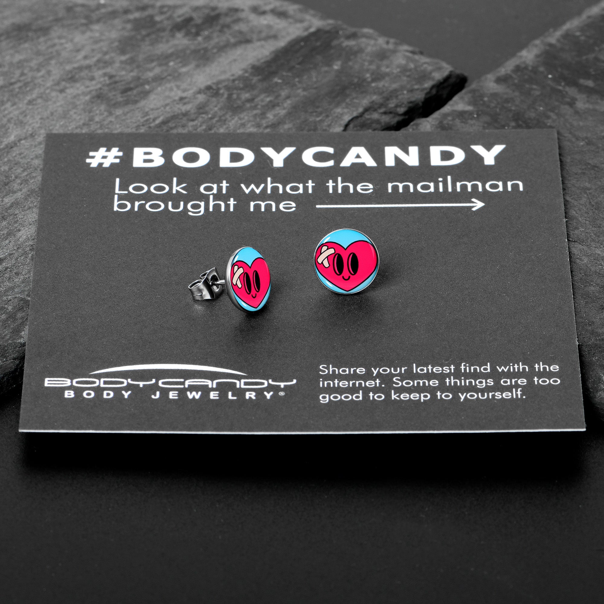 BodyCandy Heartbreak Bandaged Heart Stud Earrings by Onyx O — in-use photo