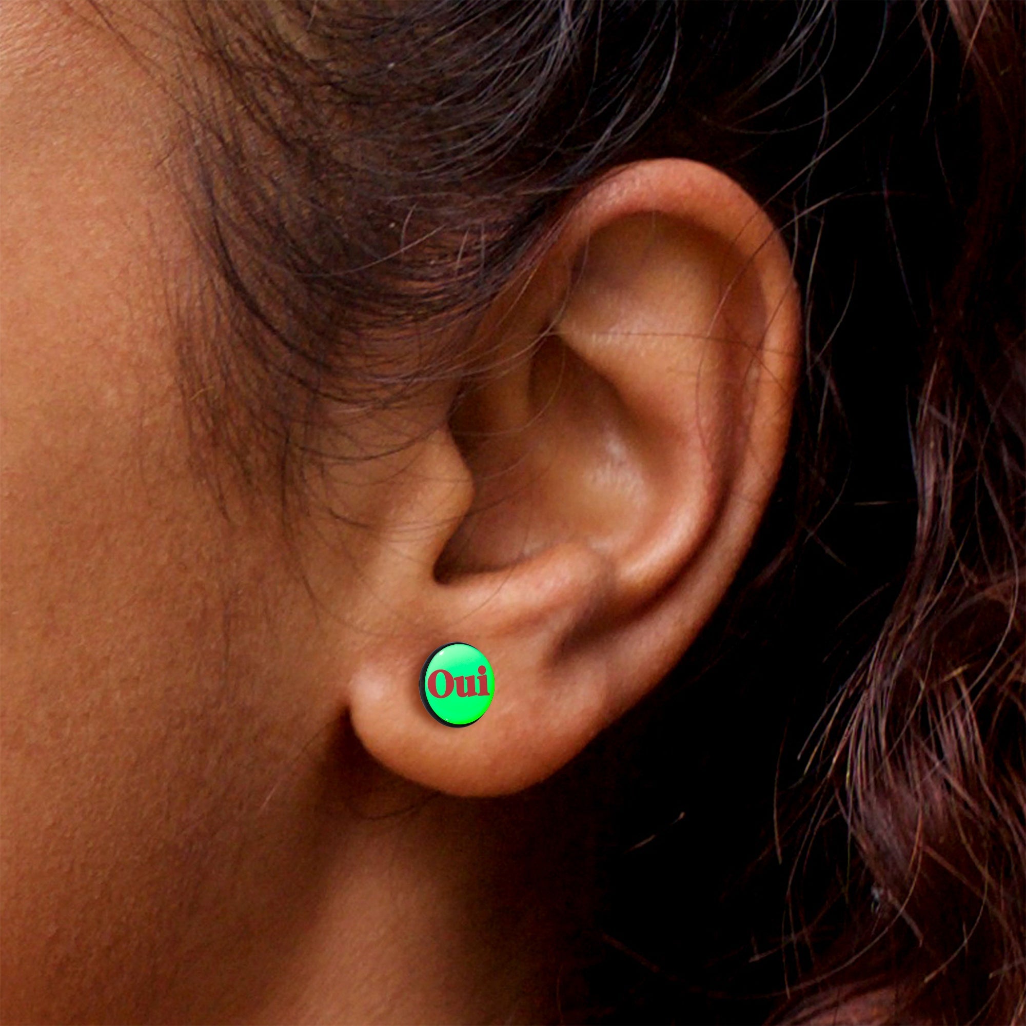 BodyCandy Black Anodized OUI Glow in the Dark Stud Earrings by Onyx O — in-use photo
